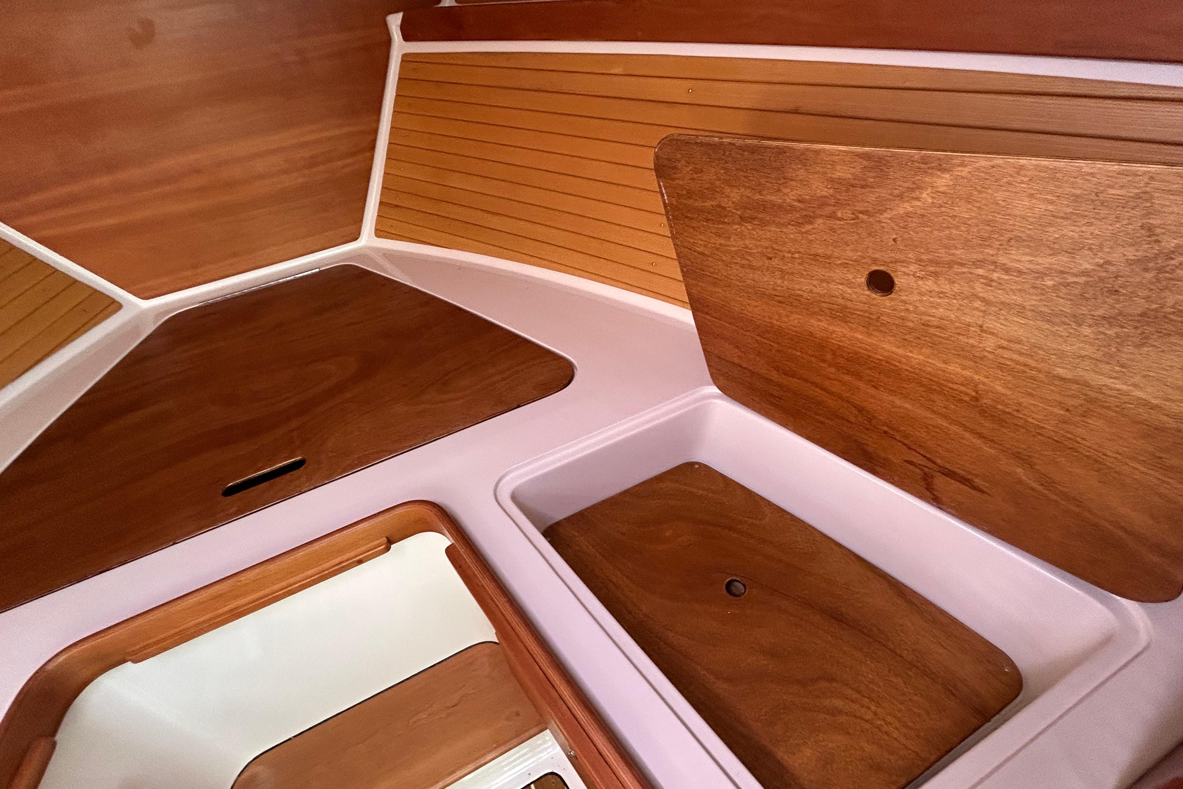 Interior of 2008 Back Cove 33 boat with wooden paneling and storage compartments.