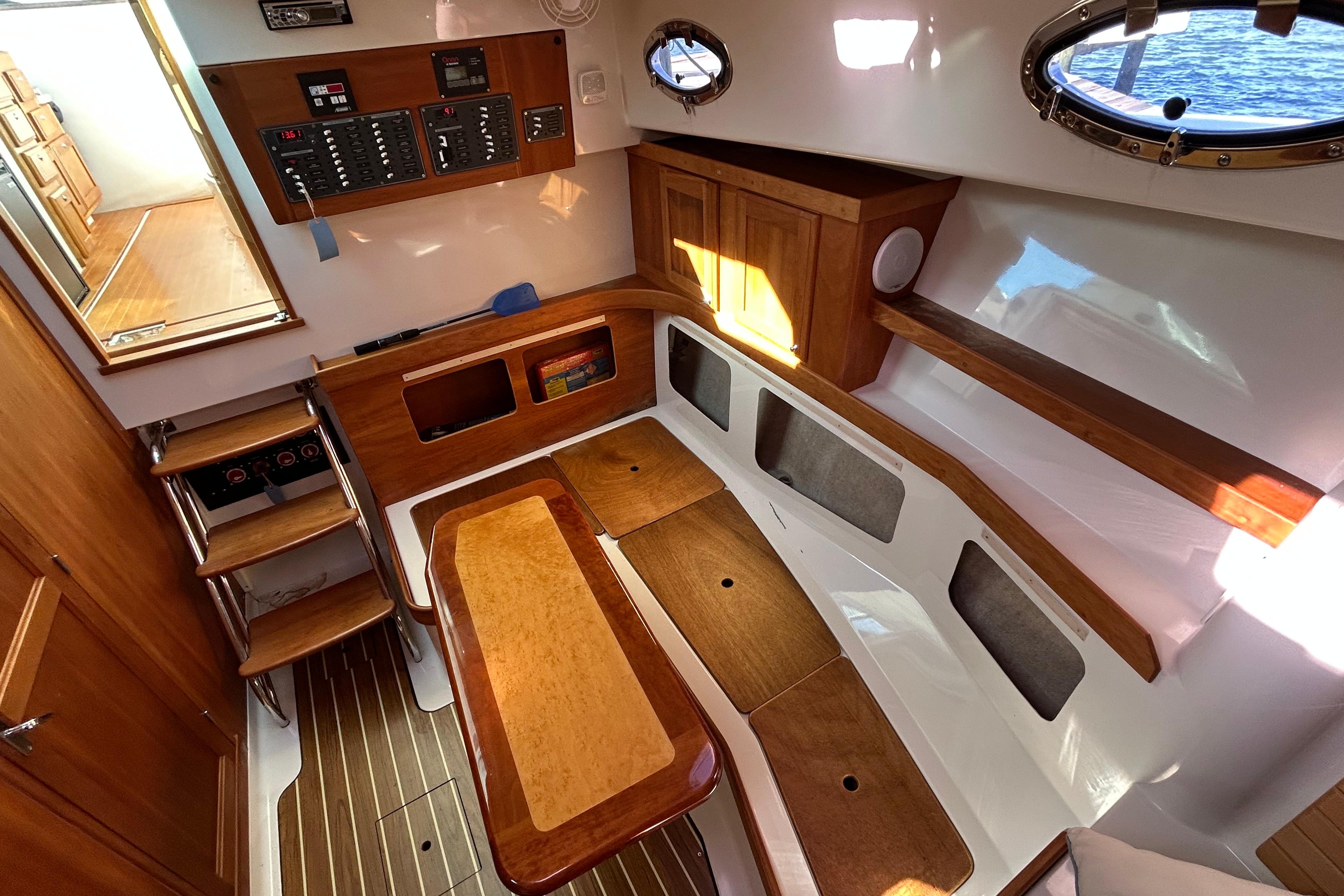 2008 Back Cove 33 interior with wooden cabinetry, seating, and control panel.