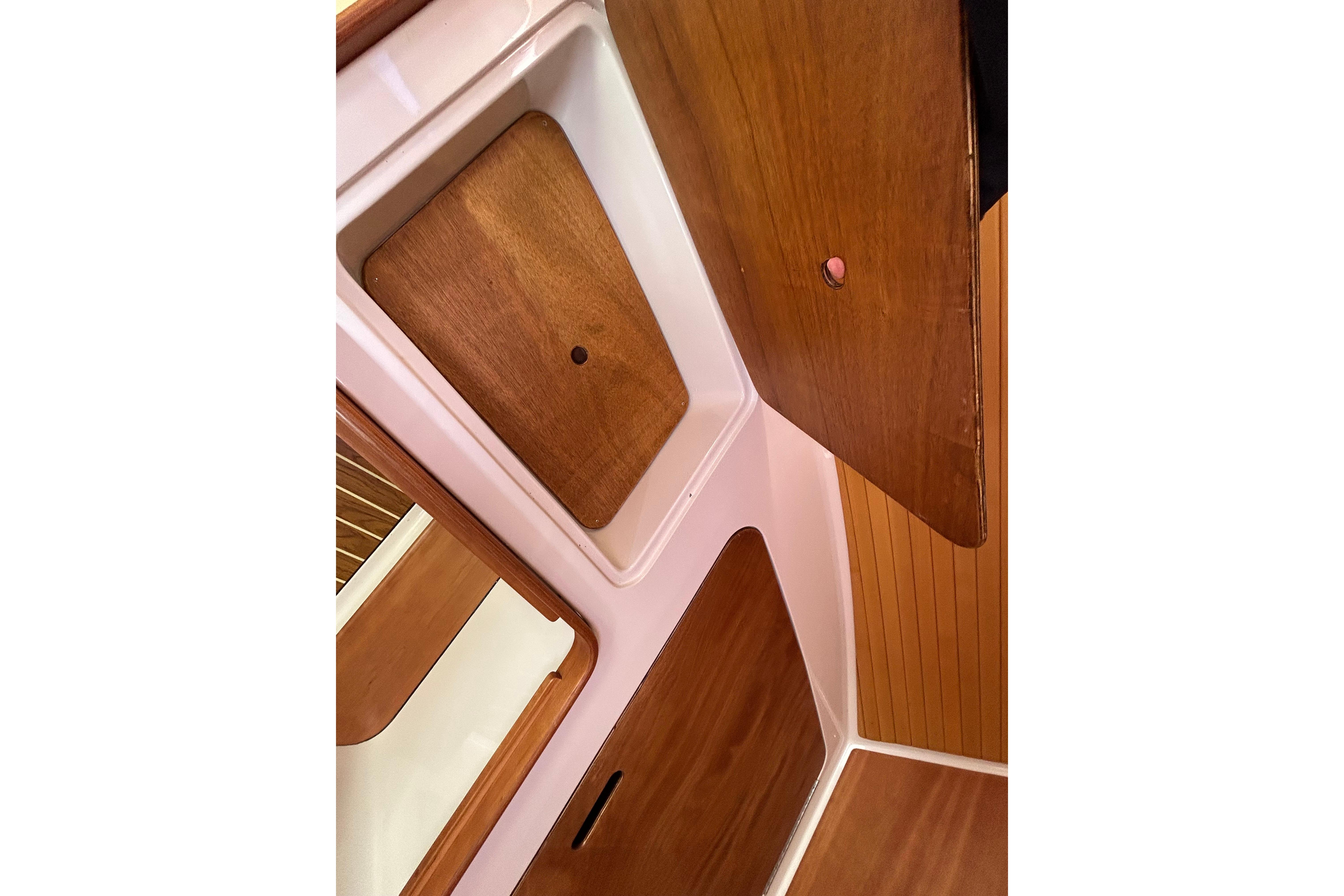 2008 Back Cove 33 interior with wooden cabinetry and storage compartments.