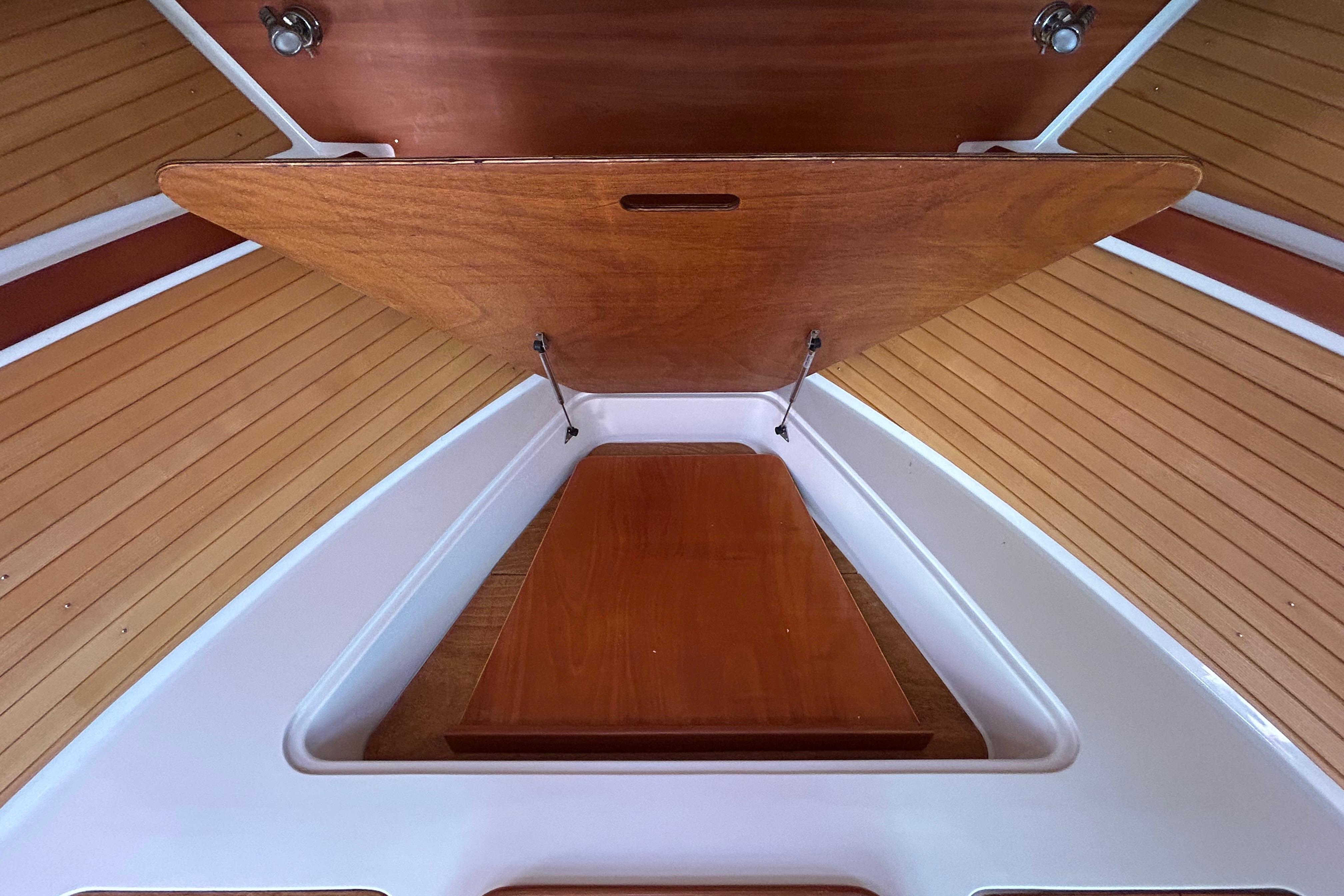 2008 Back Cove 33 interior with wooden paneling and storage compartment.