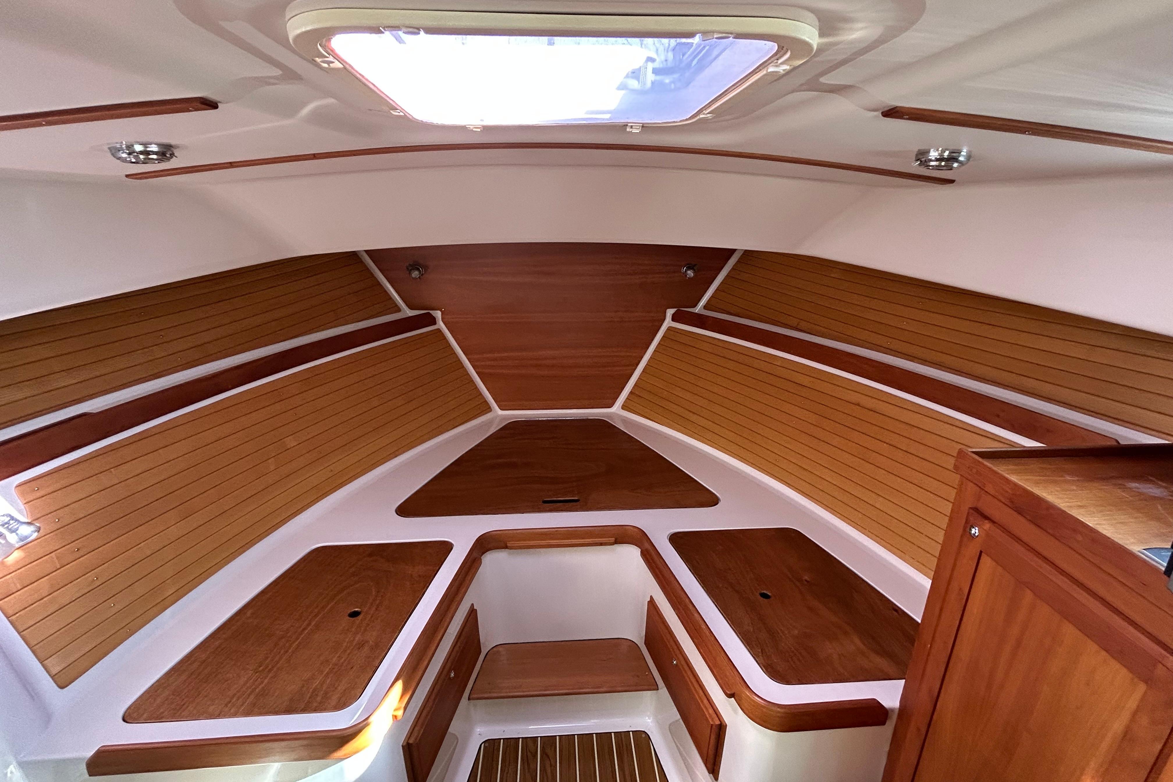 2008 Back Cove 33 boat interior with wood paneling and overhead hatch.