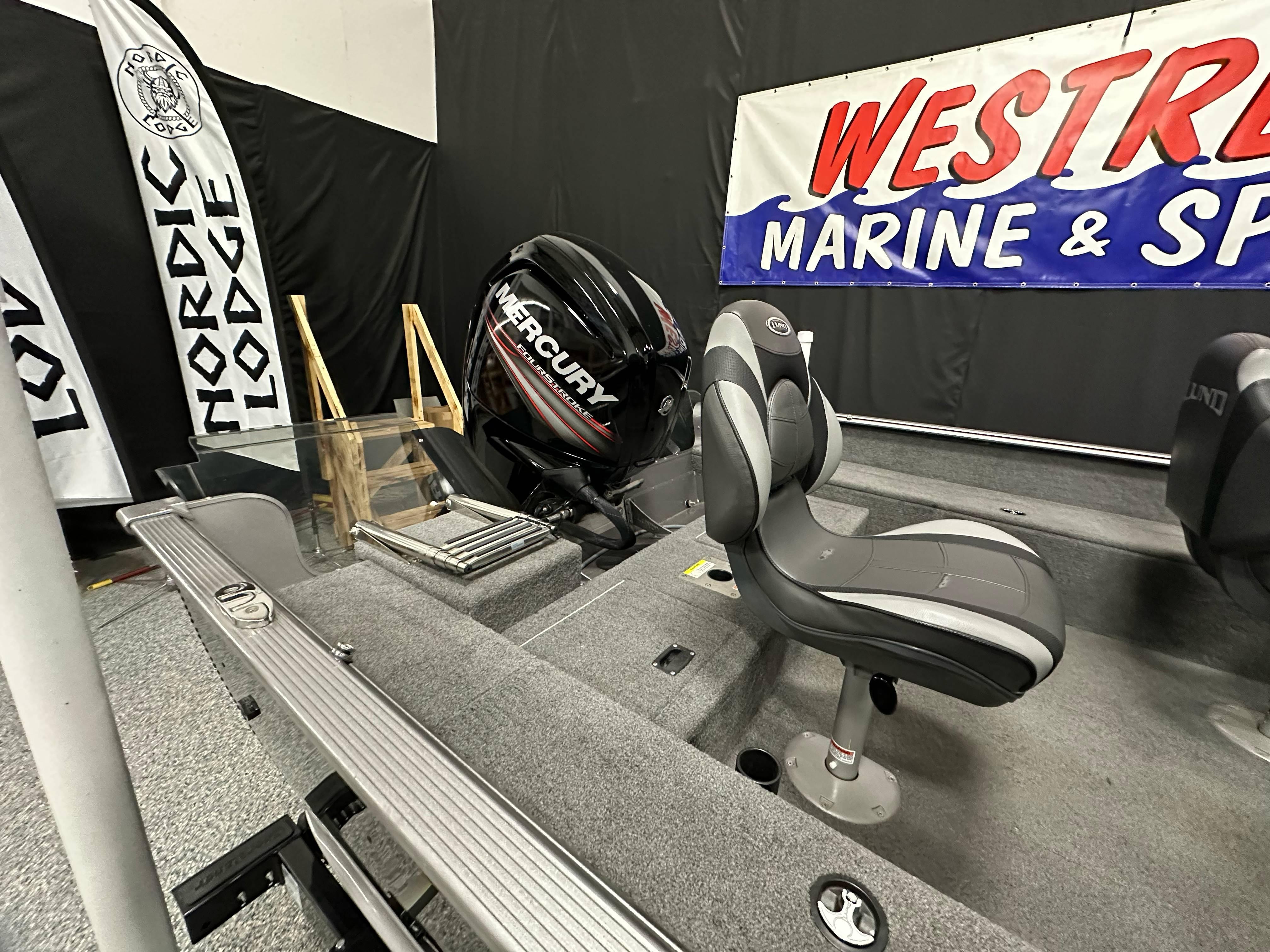 2017 Lund 1675 Impact SS boat interior with Mercury engine at Westrum Marine & Sport display.