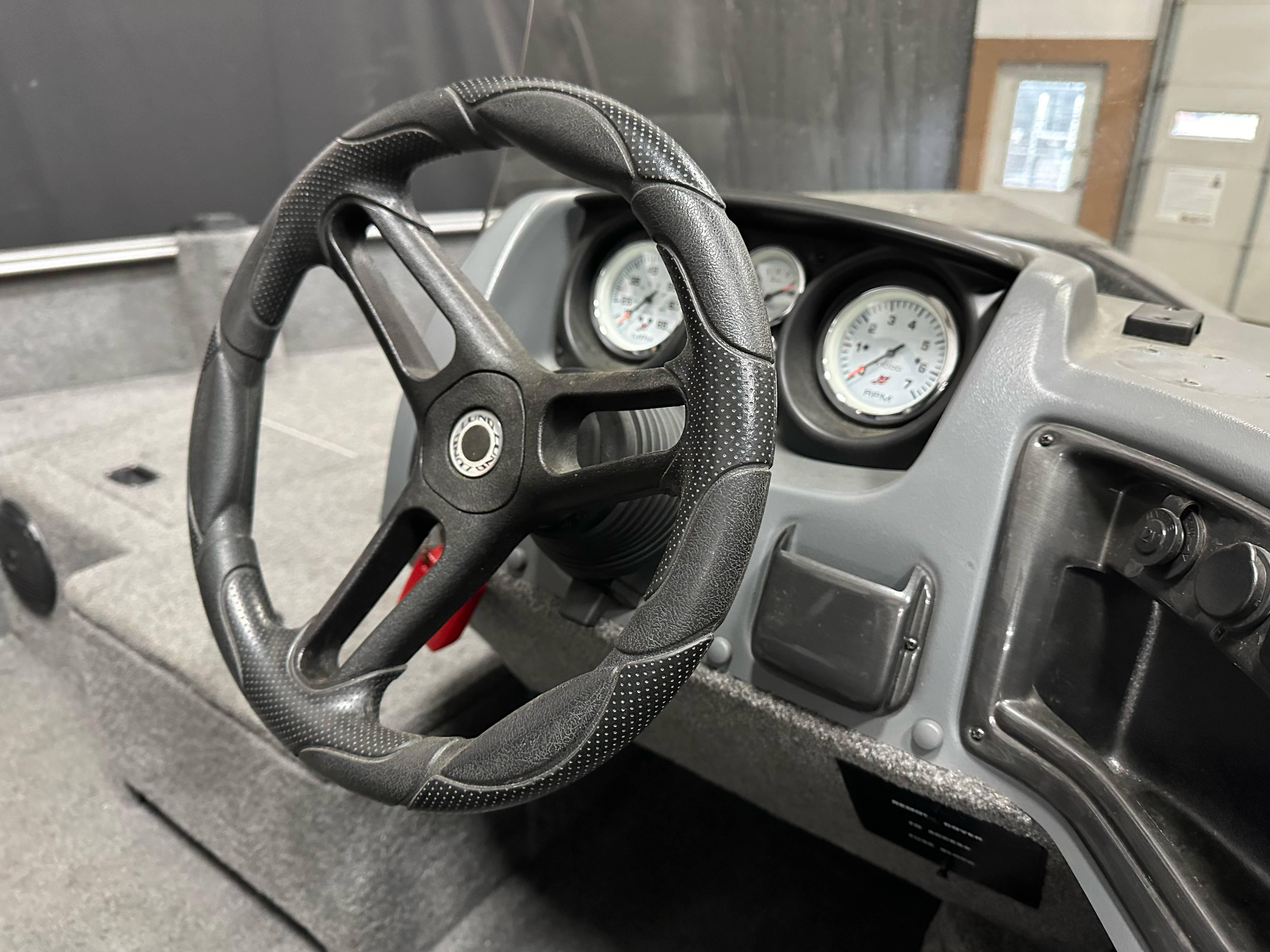 Steering wheel and dashboard of 2017 Lund 1675 Impact SS boat.