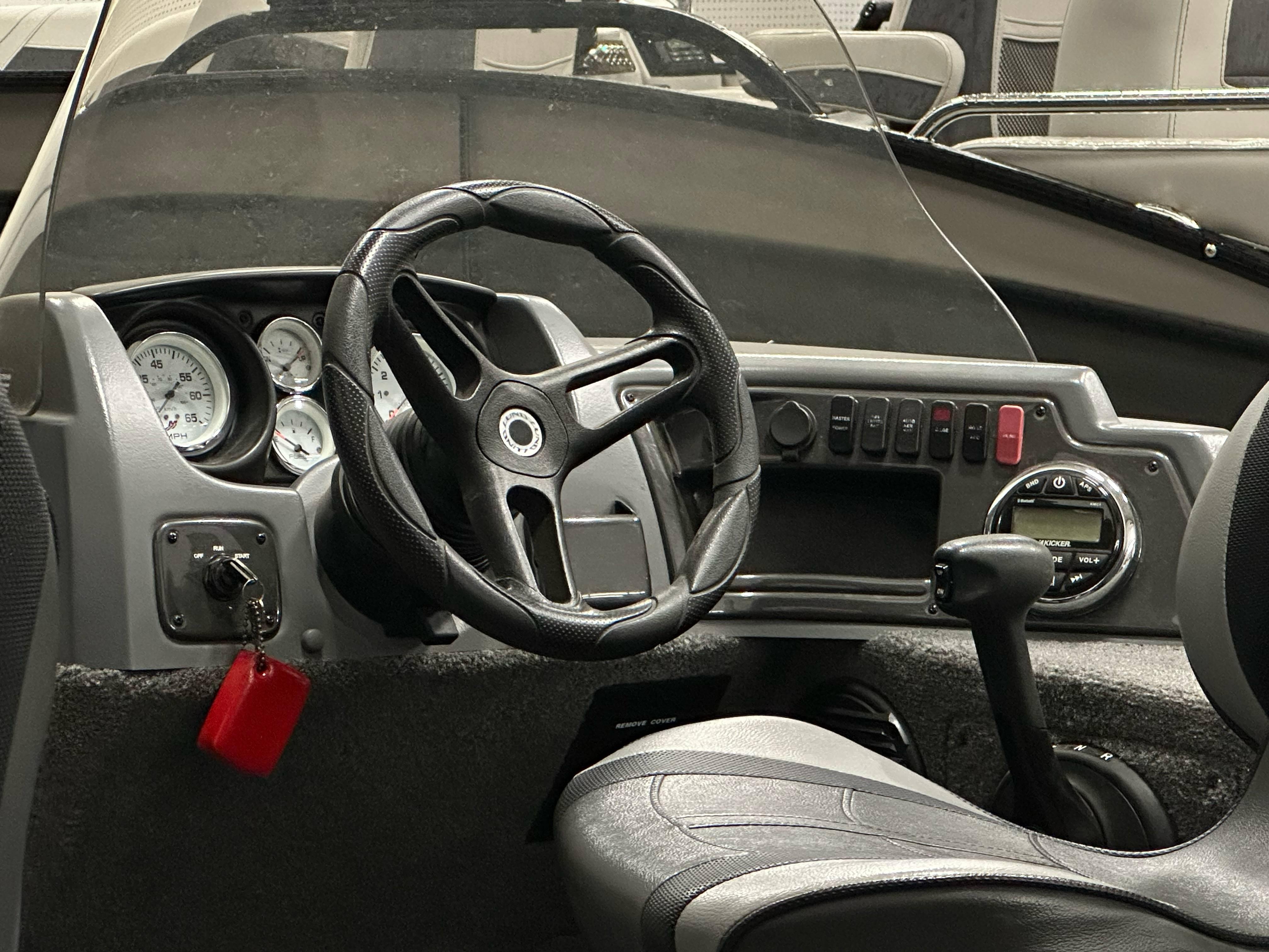 2017 Lund 1675 Impact SS boat dashboard with steering wheel and control panel.