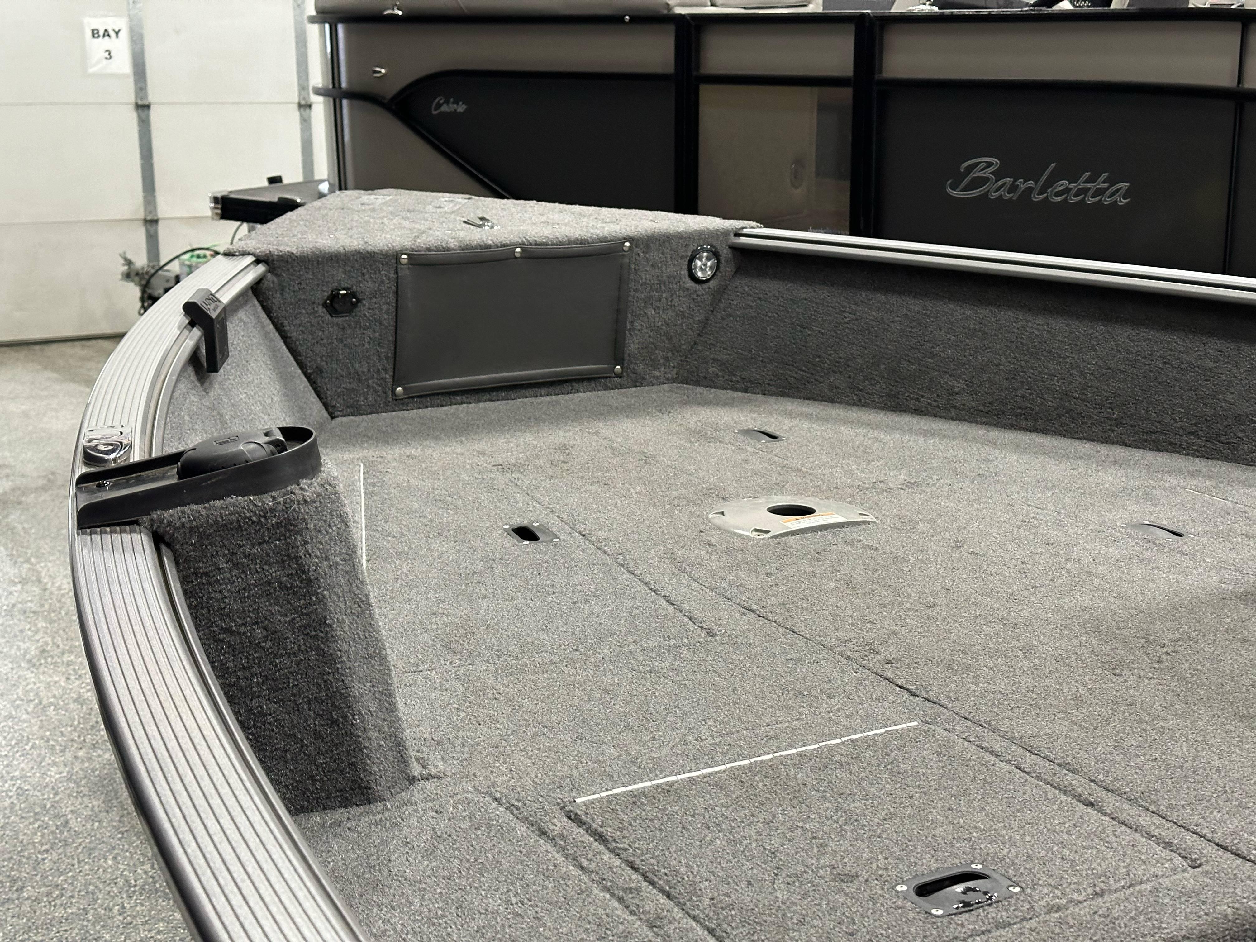 2017 Lund 1675 Impact SS boat interior with gray carpeted deck.
