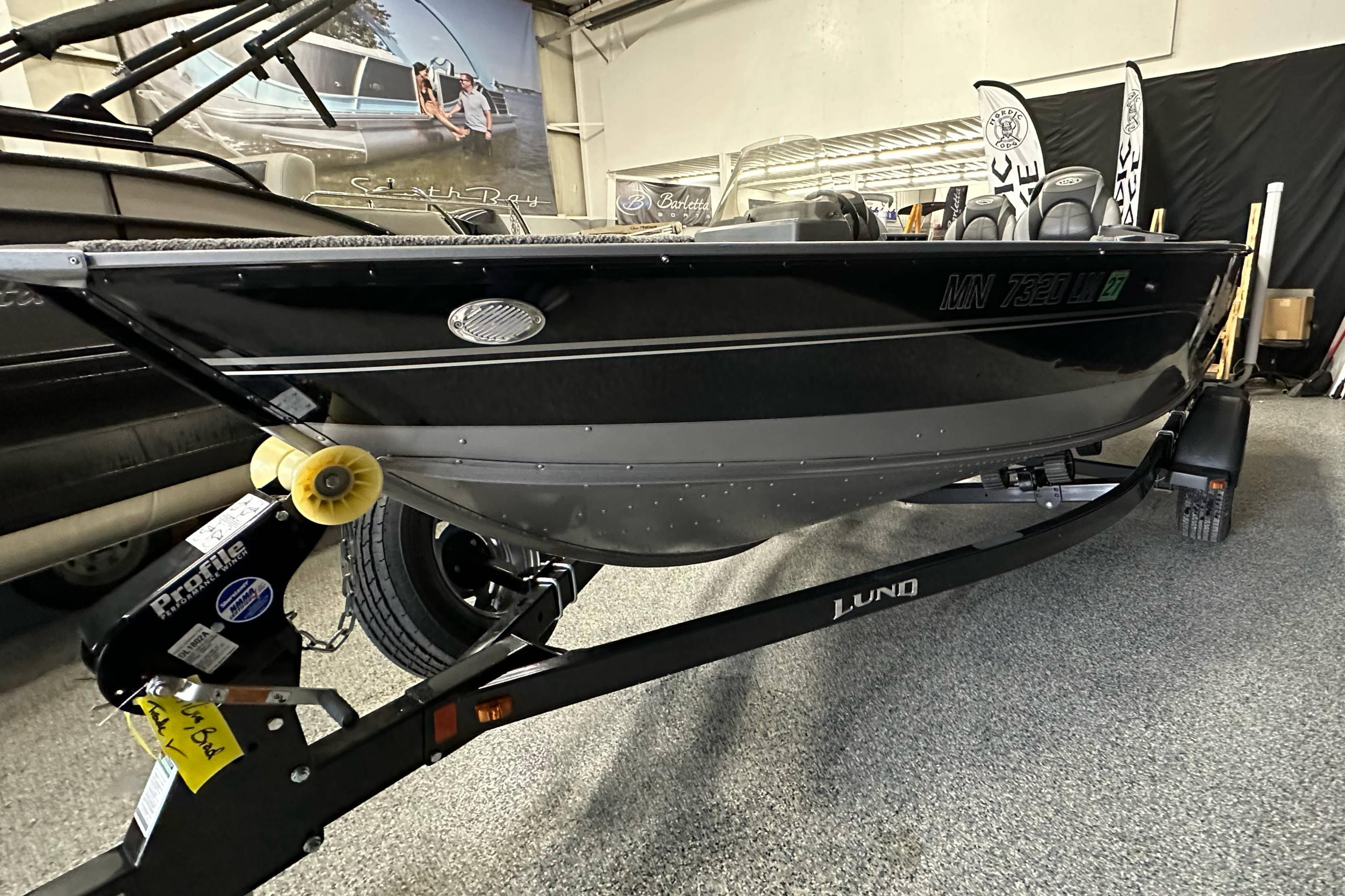 2017 Lund 1675 Impact SS boat on trailer in showroom.