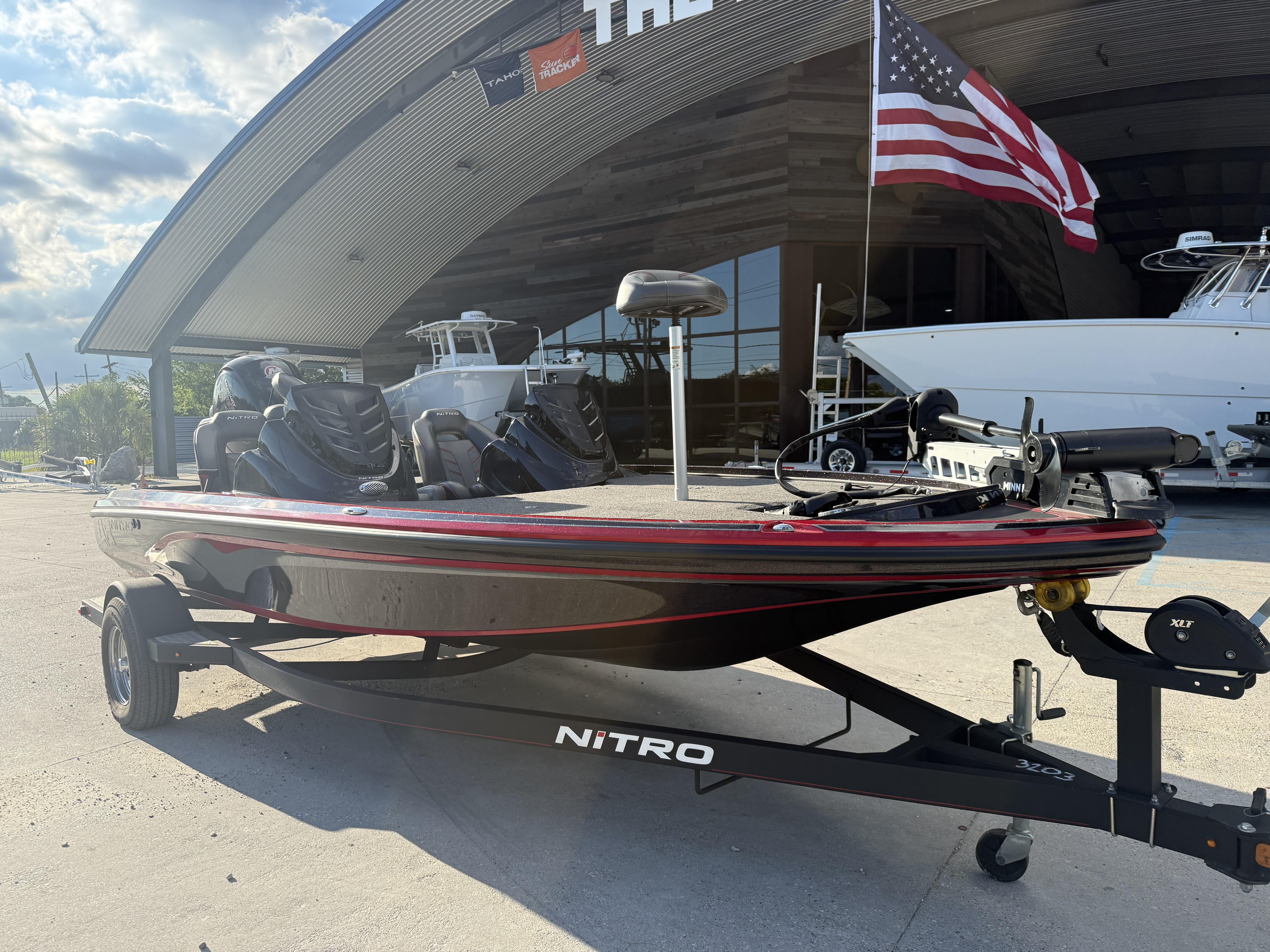 2019 Nitro Z18 DC boat on trailer, parked outside with American flag in background.