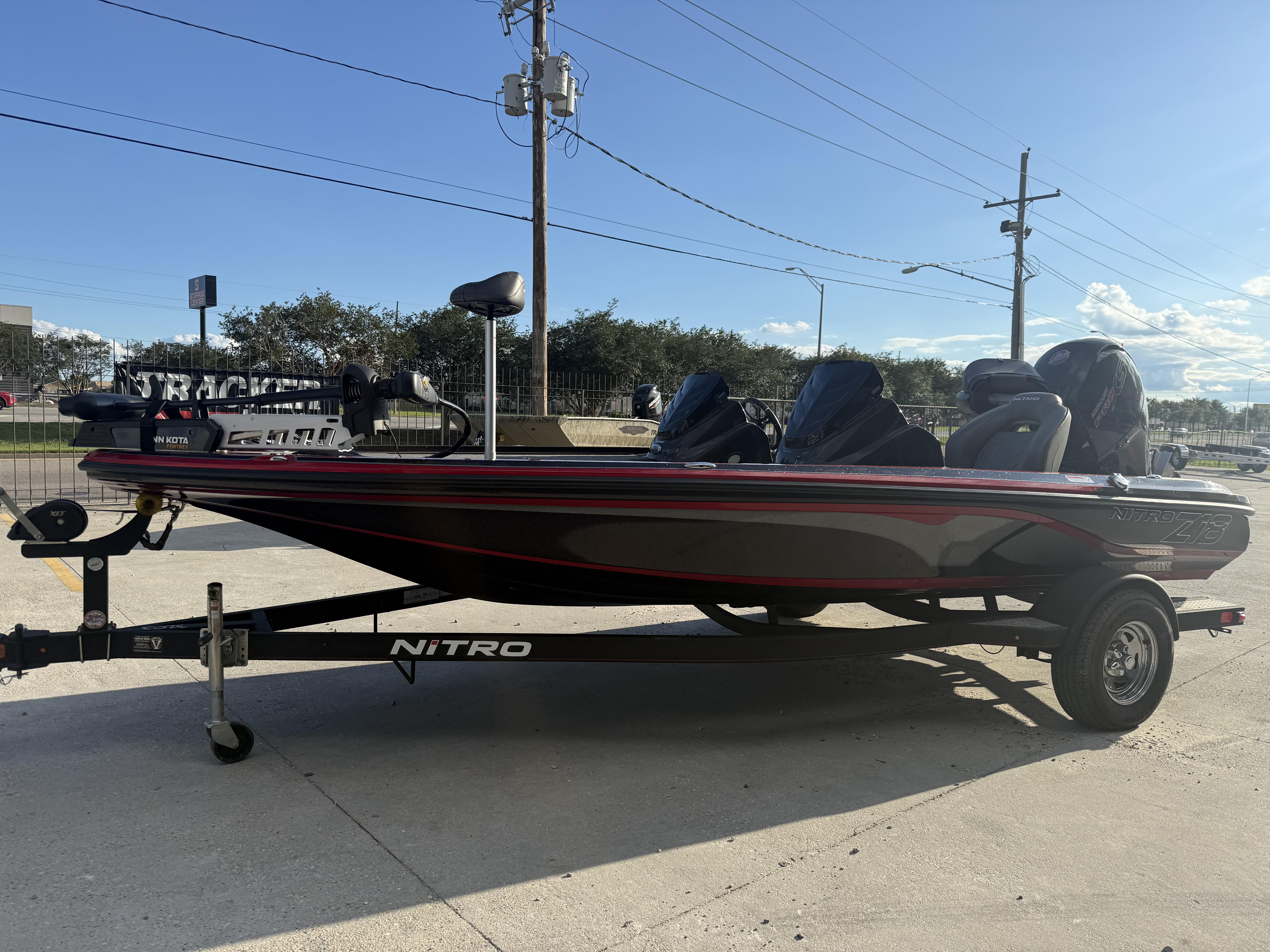 2019 Nitro Z18 DC boat on trailer, parked outdoors under clear sky.