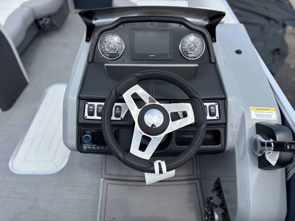 Steering console of 2025 Godfrey Monaco 235 DFL boat with modern controls and dashboard.