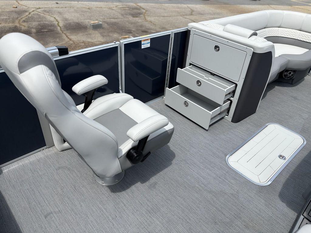 2025 Godfrey Monaco 235 DFL boat interior with seating and storage drawers.