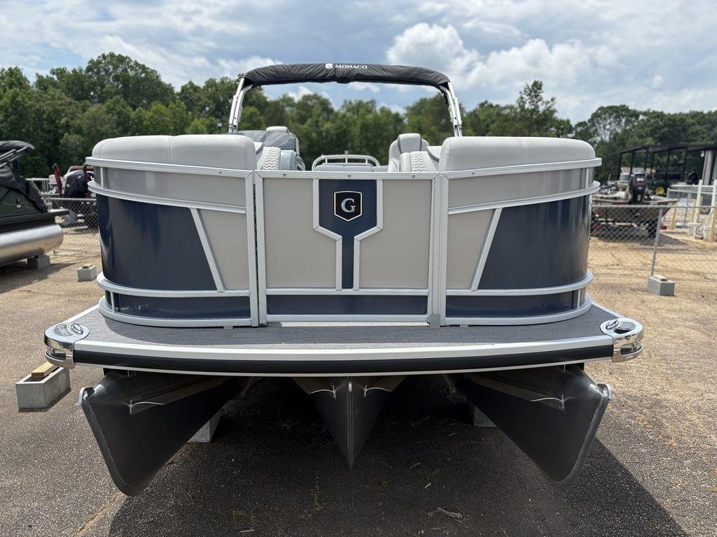 2025 Godfrey Monaco 235 DFL pontoon boat, rear view, parked outdoors.
