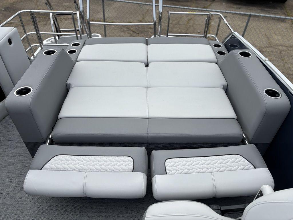 2025 Godfrey Monaco 235 DFL boat interior with luxurious gray seating and cup holders.