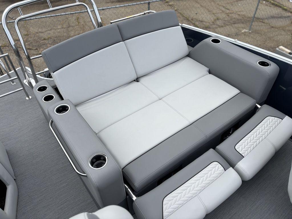 2025 Godfrey Monaco 235 DFL boat seating with cup holders, featuring gray upholstery.