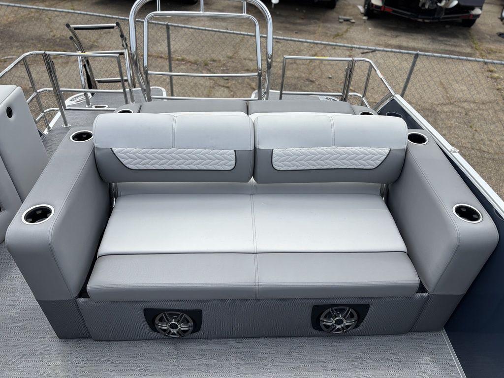 Luxurious seating on 2025 Godfrey Monaco 235 DFL pontoon boat with cup holders and speakers.