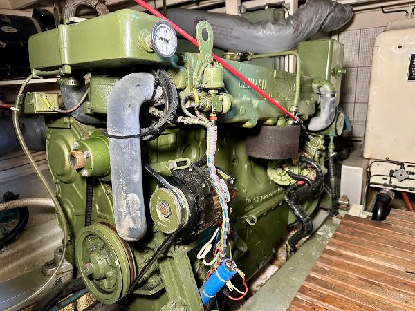 Engine room of a 1982 Grand Banks Classic boat, featuring a green marine engine.
