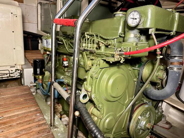 Engine room of a 1982 Grand Banks Classic boat, showcasing a green marine engine.