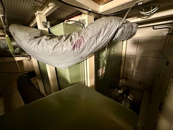 Engine room of a 1982 Grand Banks Classic boat, featuring machinery and ductwork.