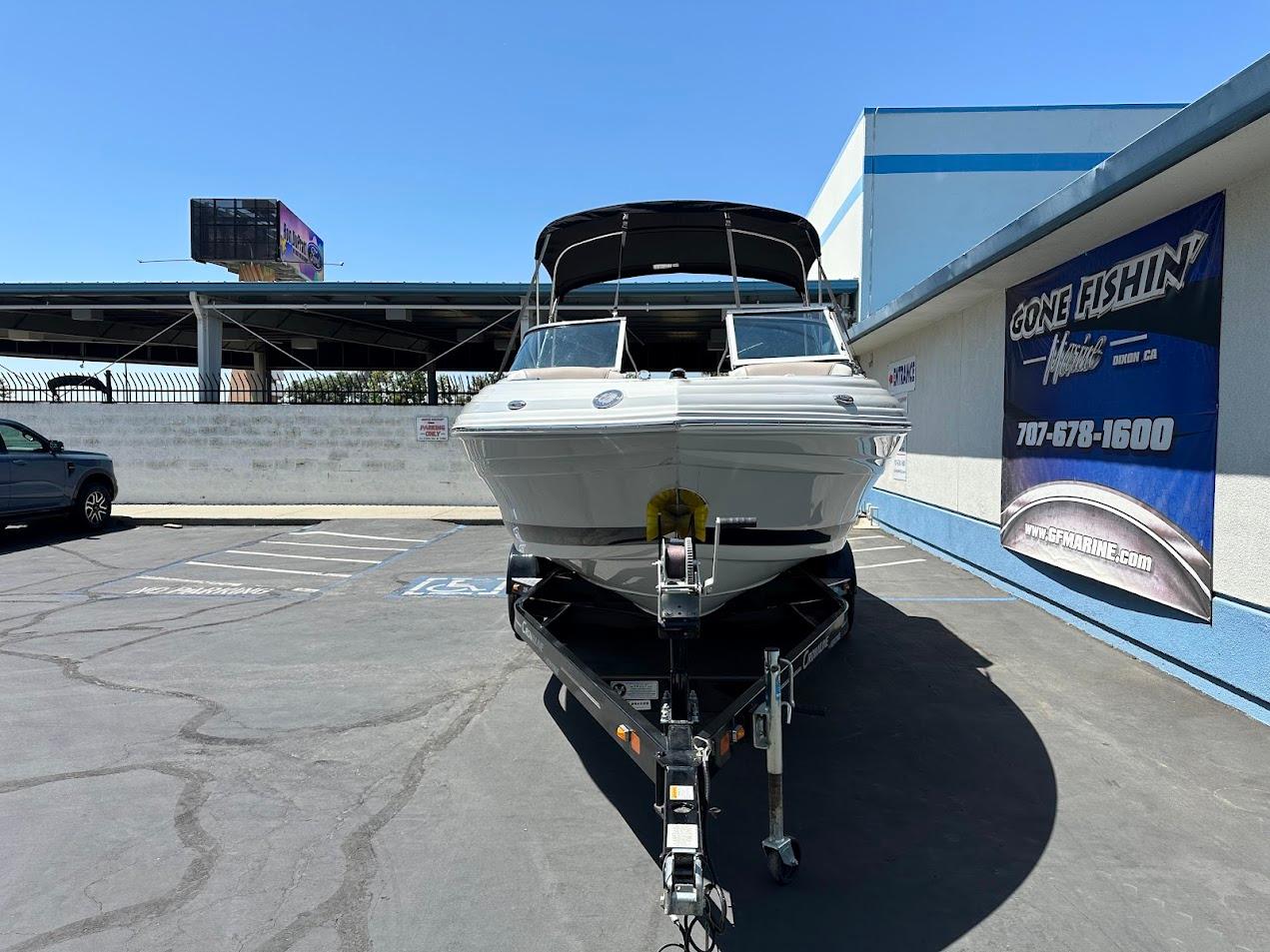 2019 Crownline 235 SS boat on trailer in parking lot, sunny day.