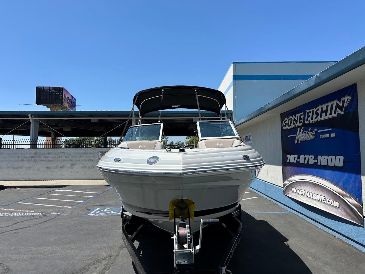 2019 Crownline 235 SS boat on trailer in parking lot, sunny day.