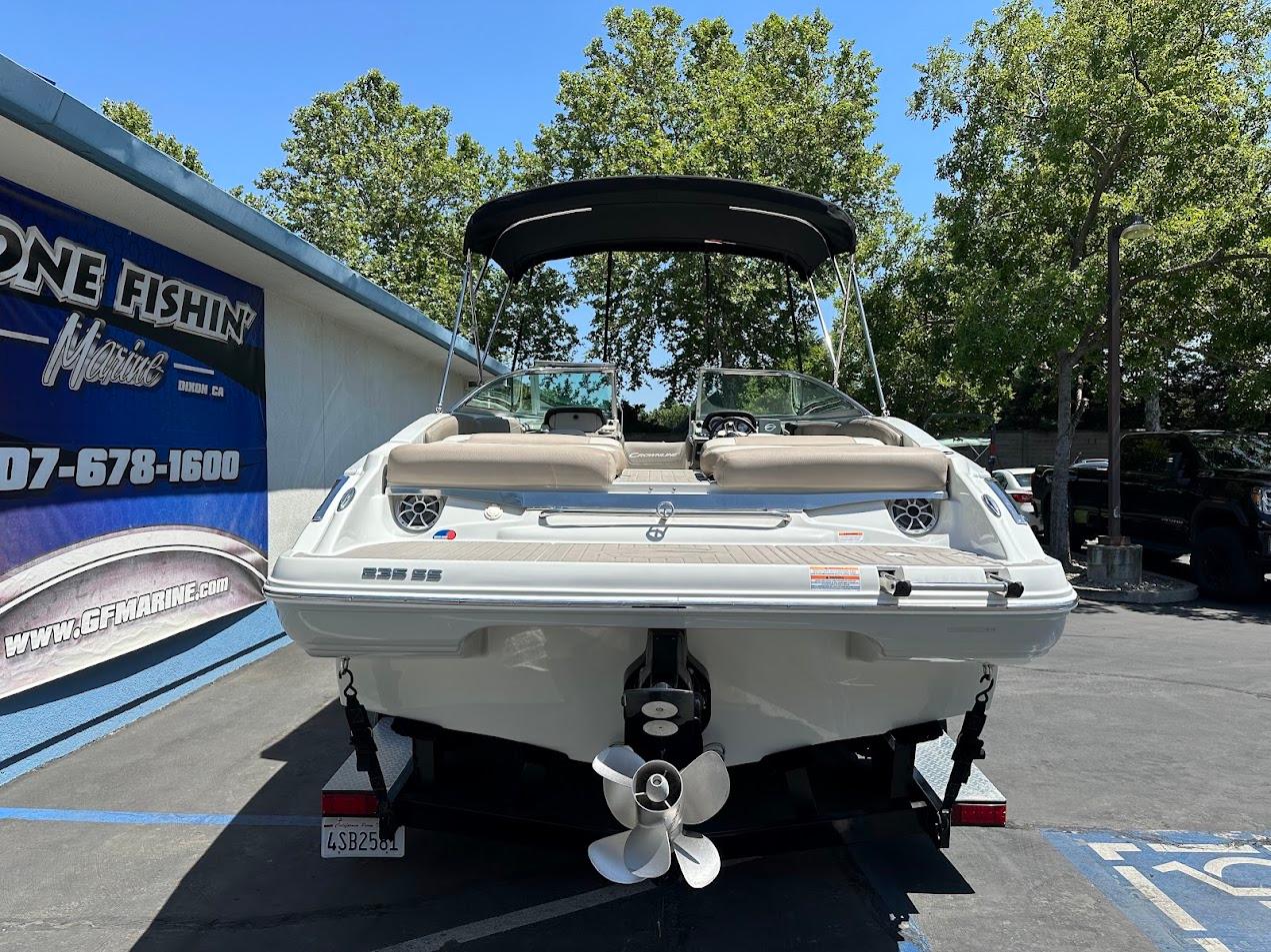 2019 Crownline 235 SS boat with canopy, parked outdoors near a building.