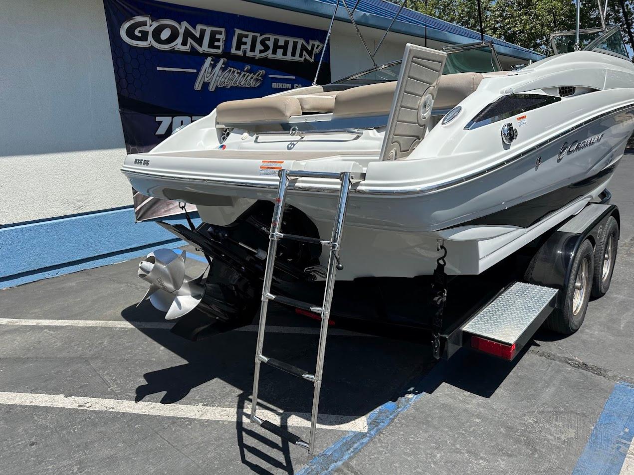 2019 Crownline 235 SS boat on trailer with ladder, parked near 