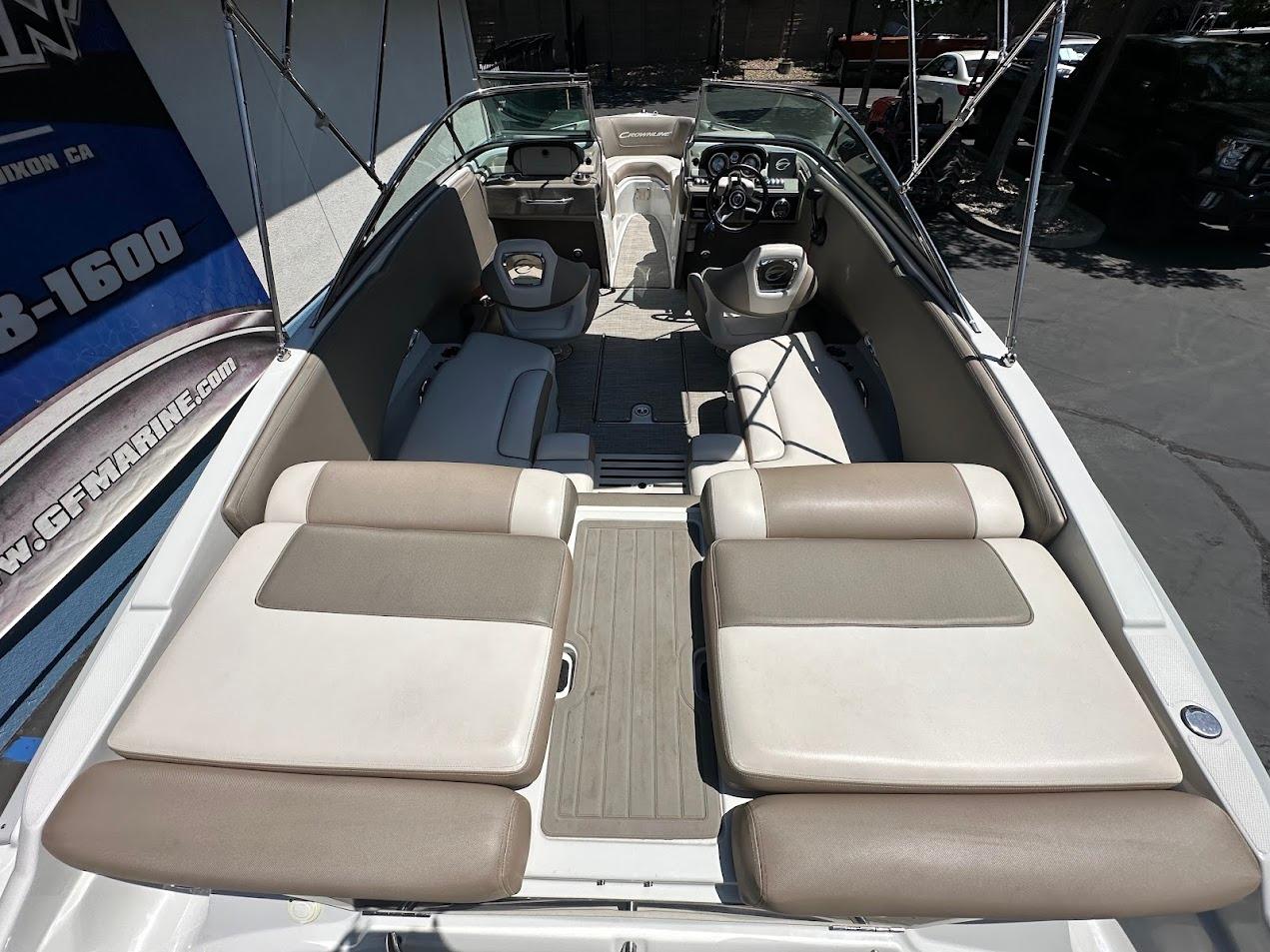 2019 Crownline 235 SS boat interior with beige seating and modern dashboard.