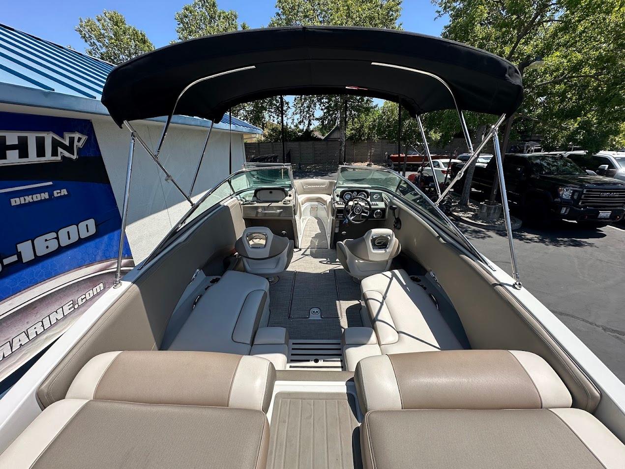2019 Crownline 235 SS boat interior with seating and canopy, parked outdoors.