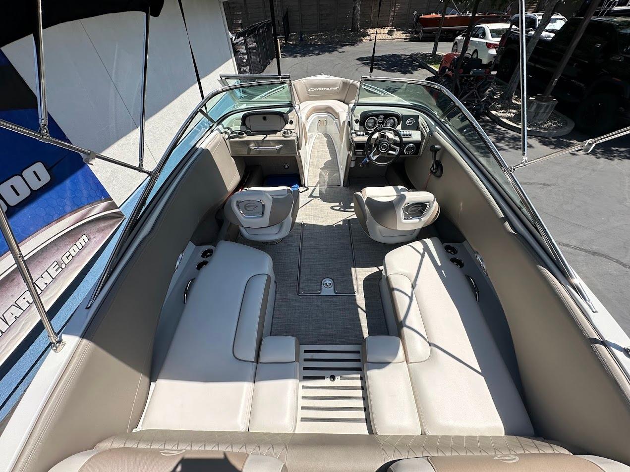 2019 Crownline 235 SS boat interior with beige seating and modern dashboard.