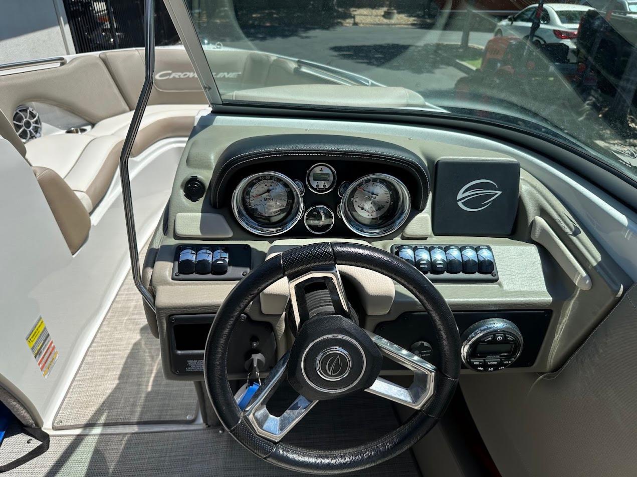 2019 Crownline 235 SS boat dashboard with steering wheel and instrument panel.