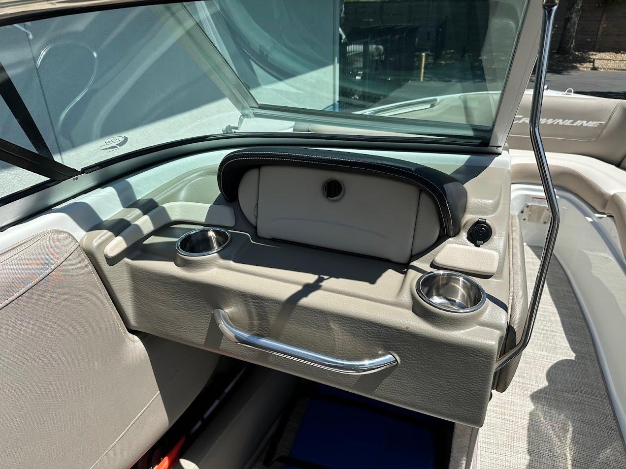 2019 Crownline 235 SS boat interior with cup holders and storage compartment.