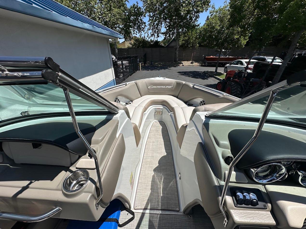 2019 Crownline 235 SS boat interior with beige seating and sleek dashboard.