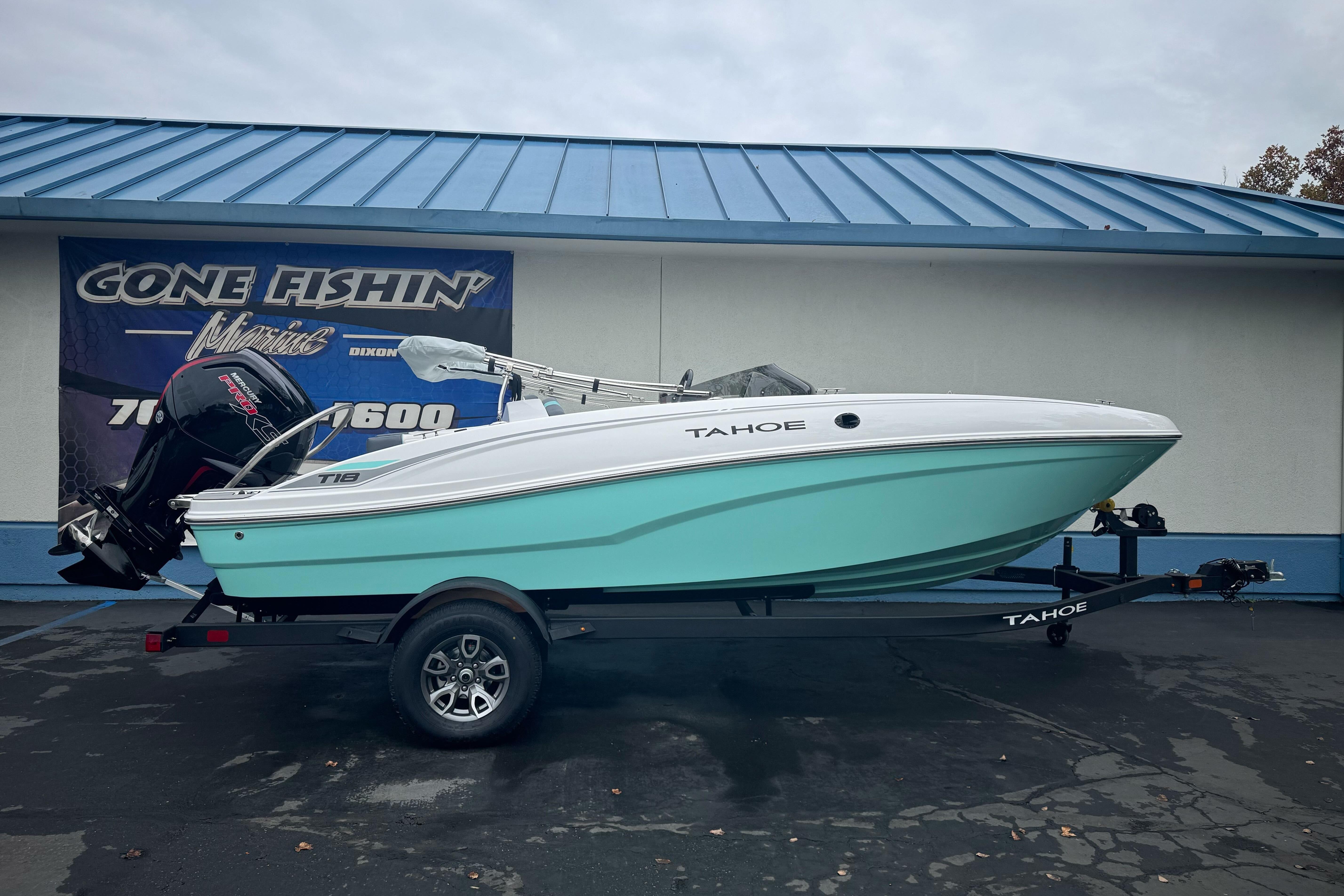 2026 Tahoe T18 boat on trailer, displayed outside a marine dealership.