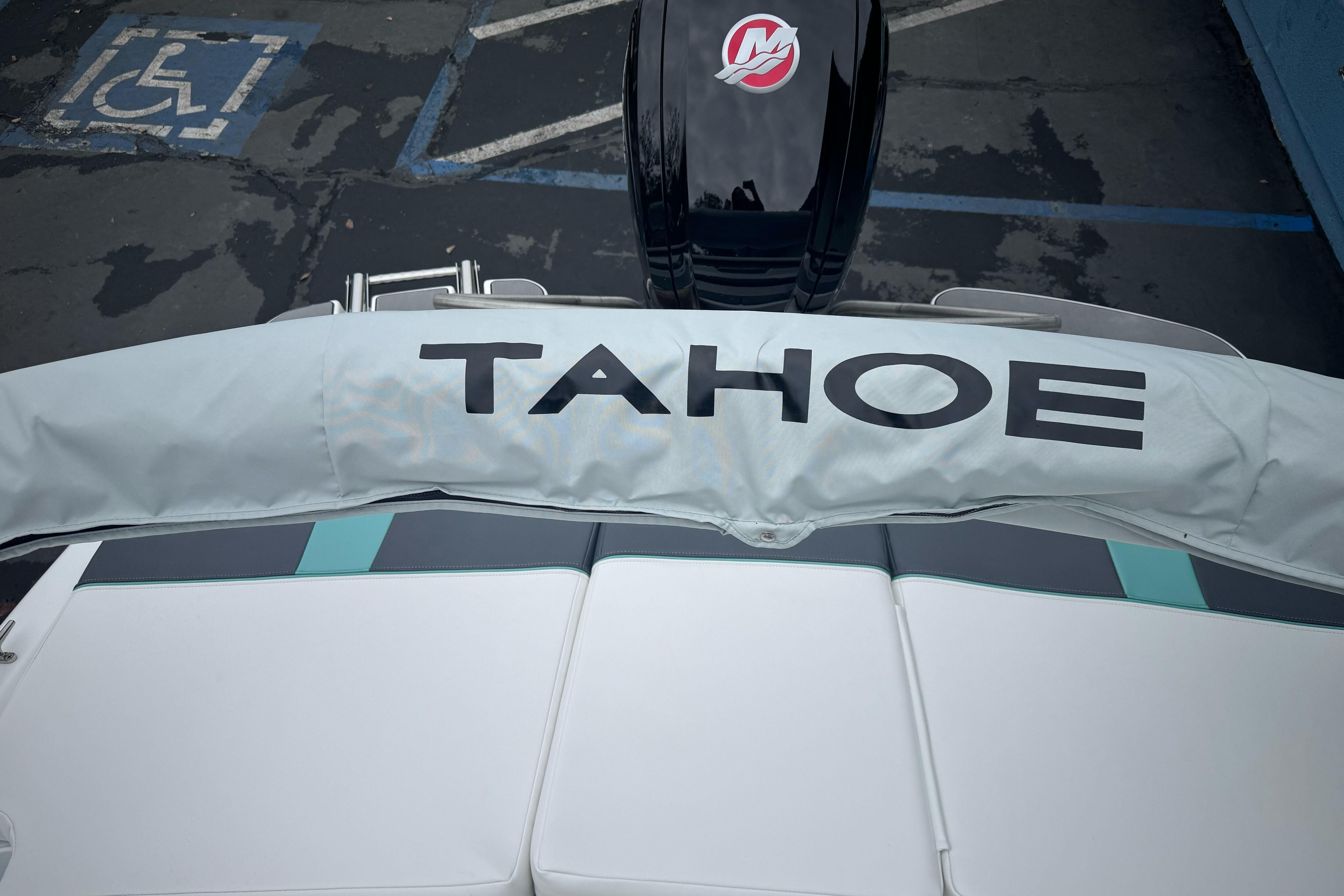 2026 Tahoe T18 boat with cover, parked in a lot with a visible handicap space.