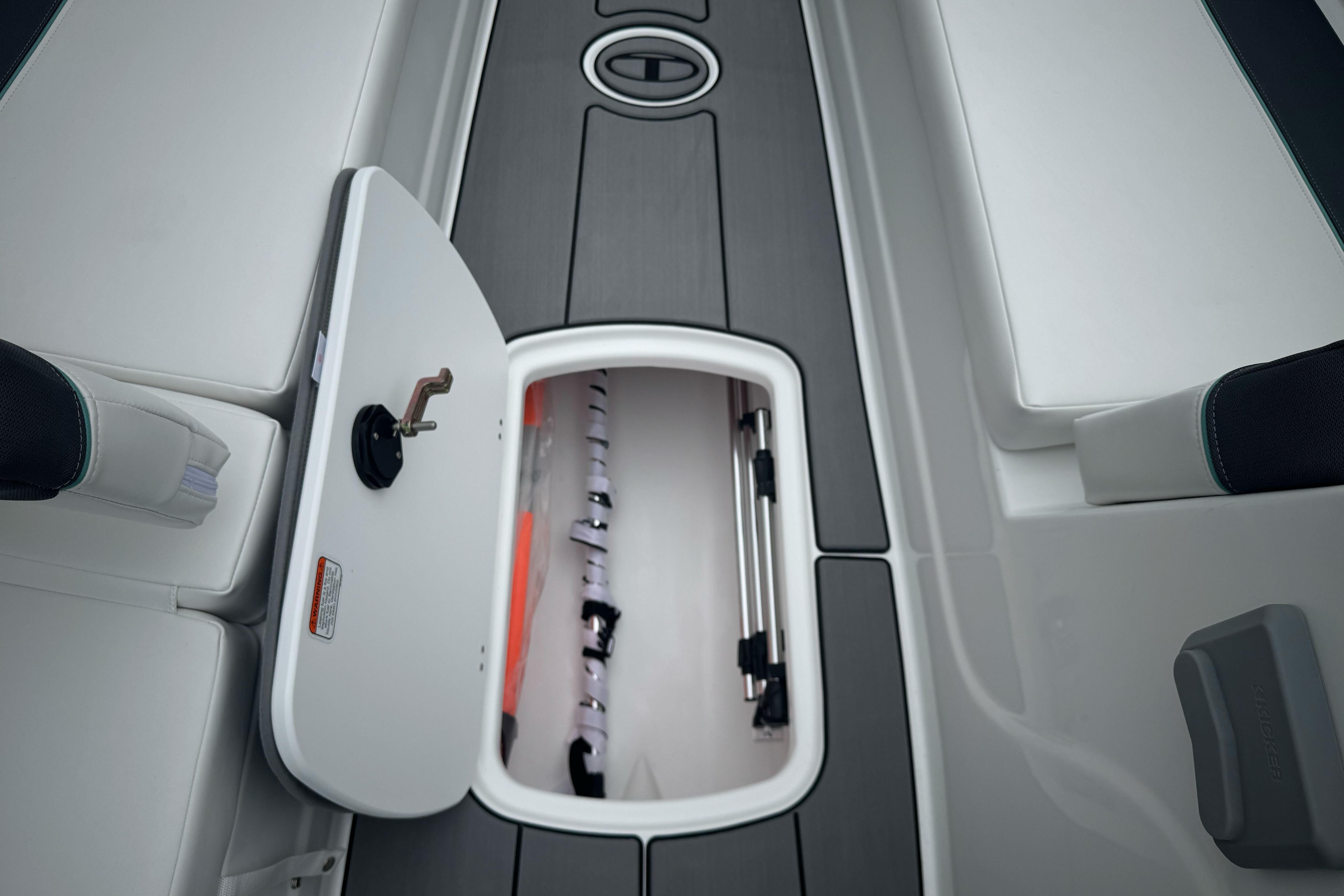 2026 Tahoe T18 boat storage compartment with open hatch, showcasing interior space.