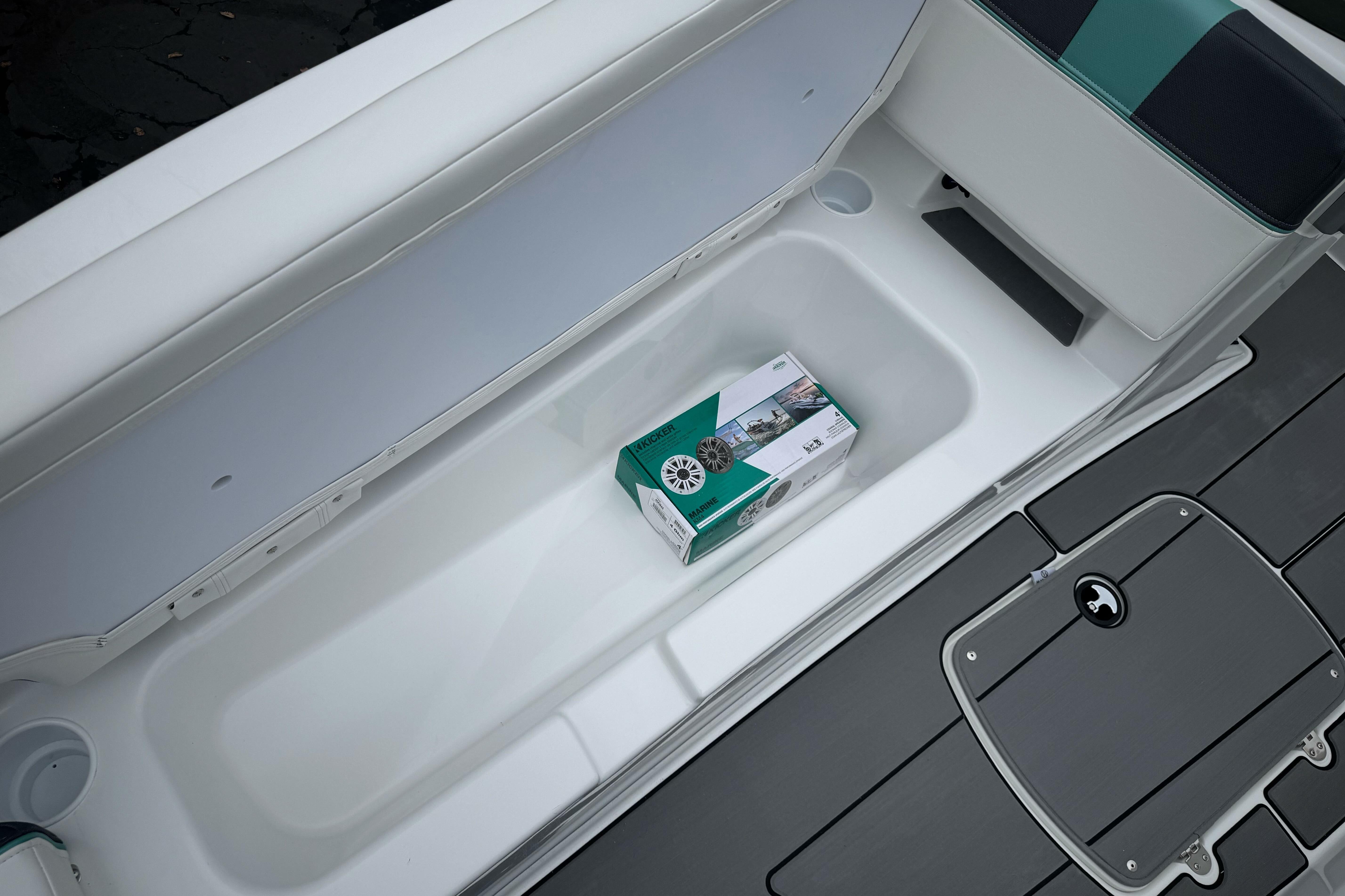 2026 Tahoe T18 boat storage compartment with a packaged marine speaker inside.