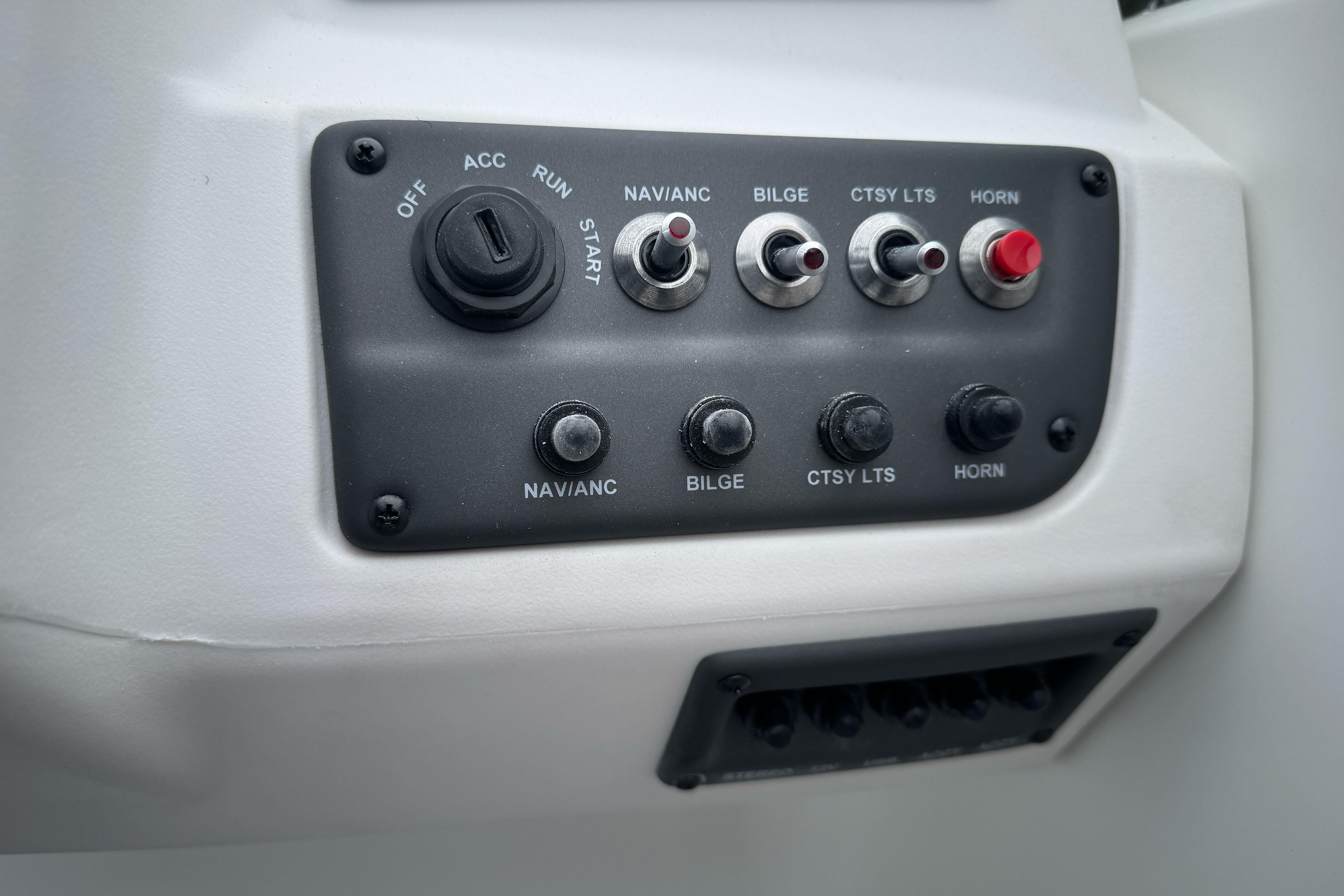 Control panel of 2026 Tahoe T18 boat with switches and ignition key.