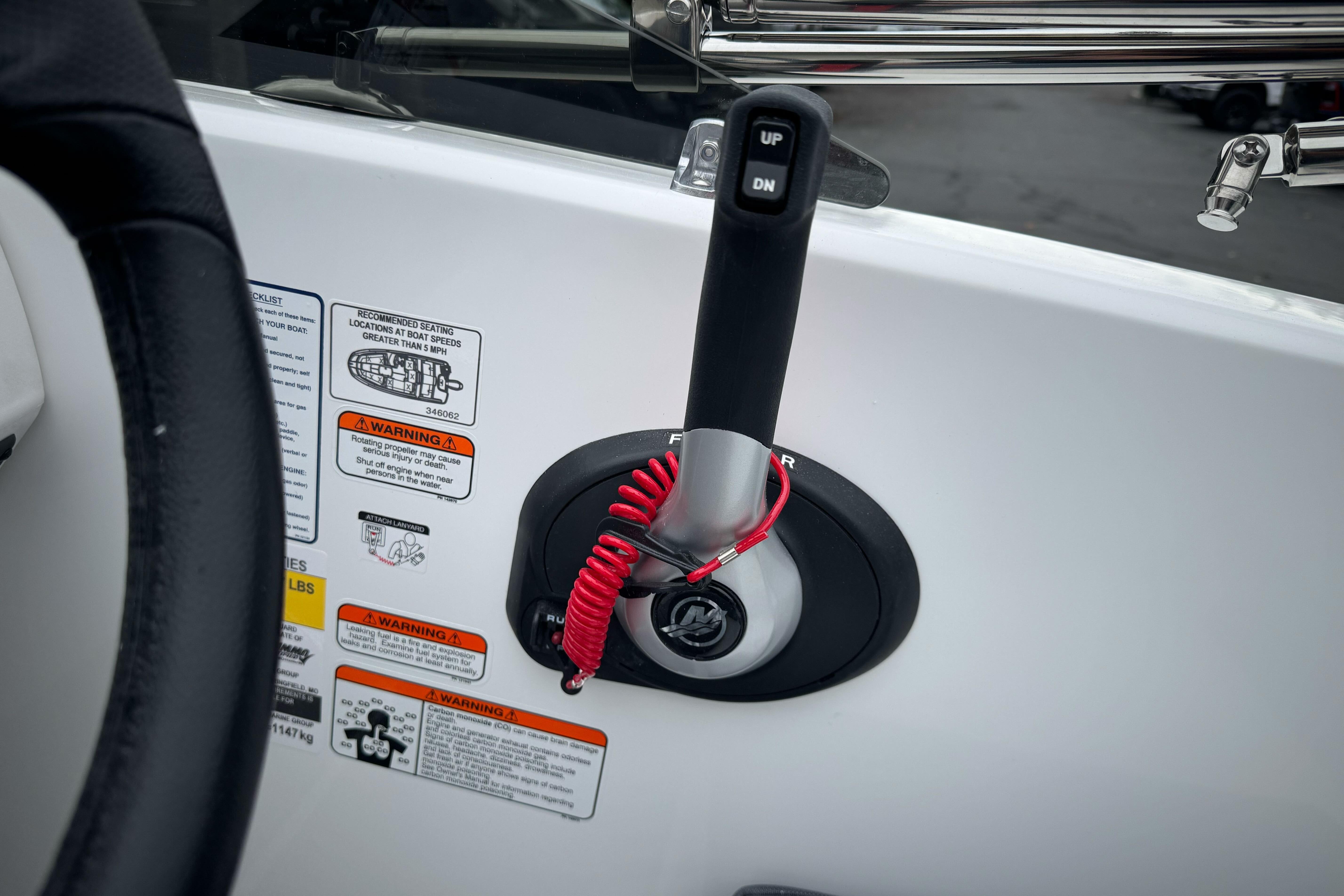 Control panel of 2026 Tahoe T18 boat with throttle lever and safety warnings.
