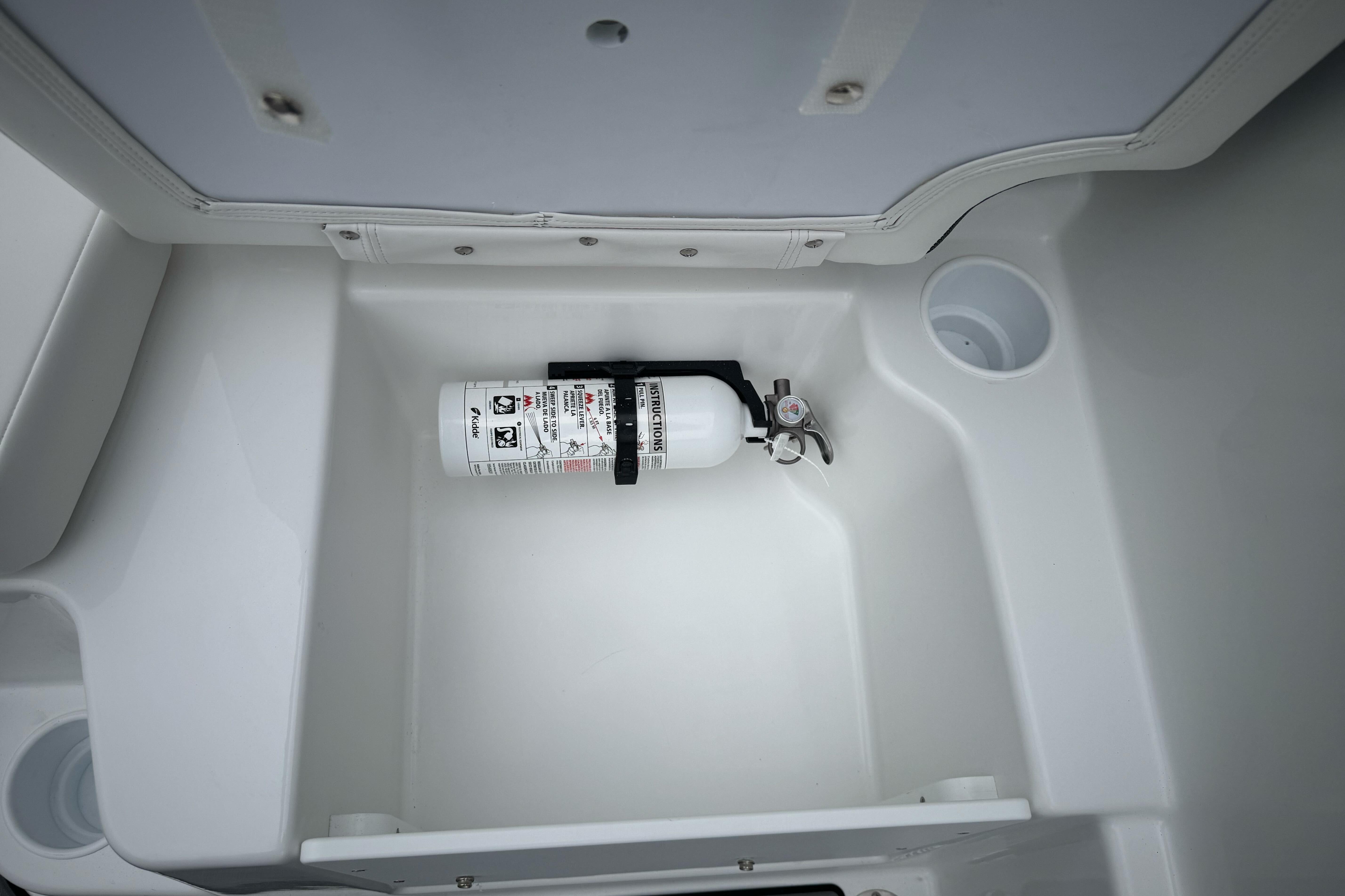 Fire extinguisher in storage compartment of 2026 Tahoe T18 boat.