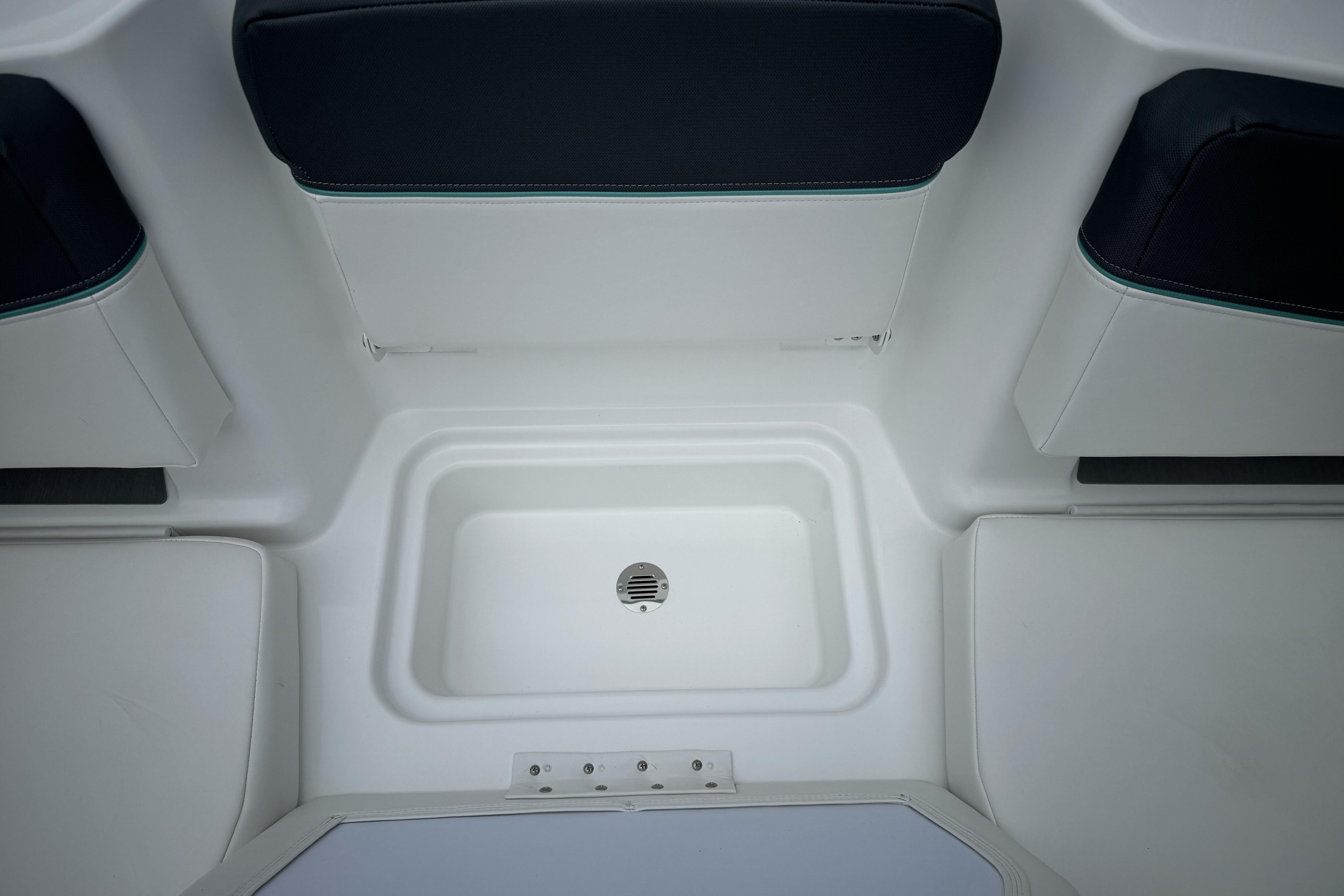 2026 Tahoe T18 boat interior with seating and storage compartment.