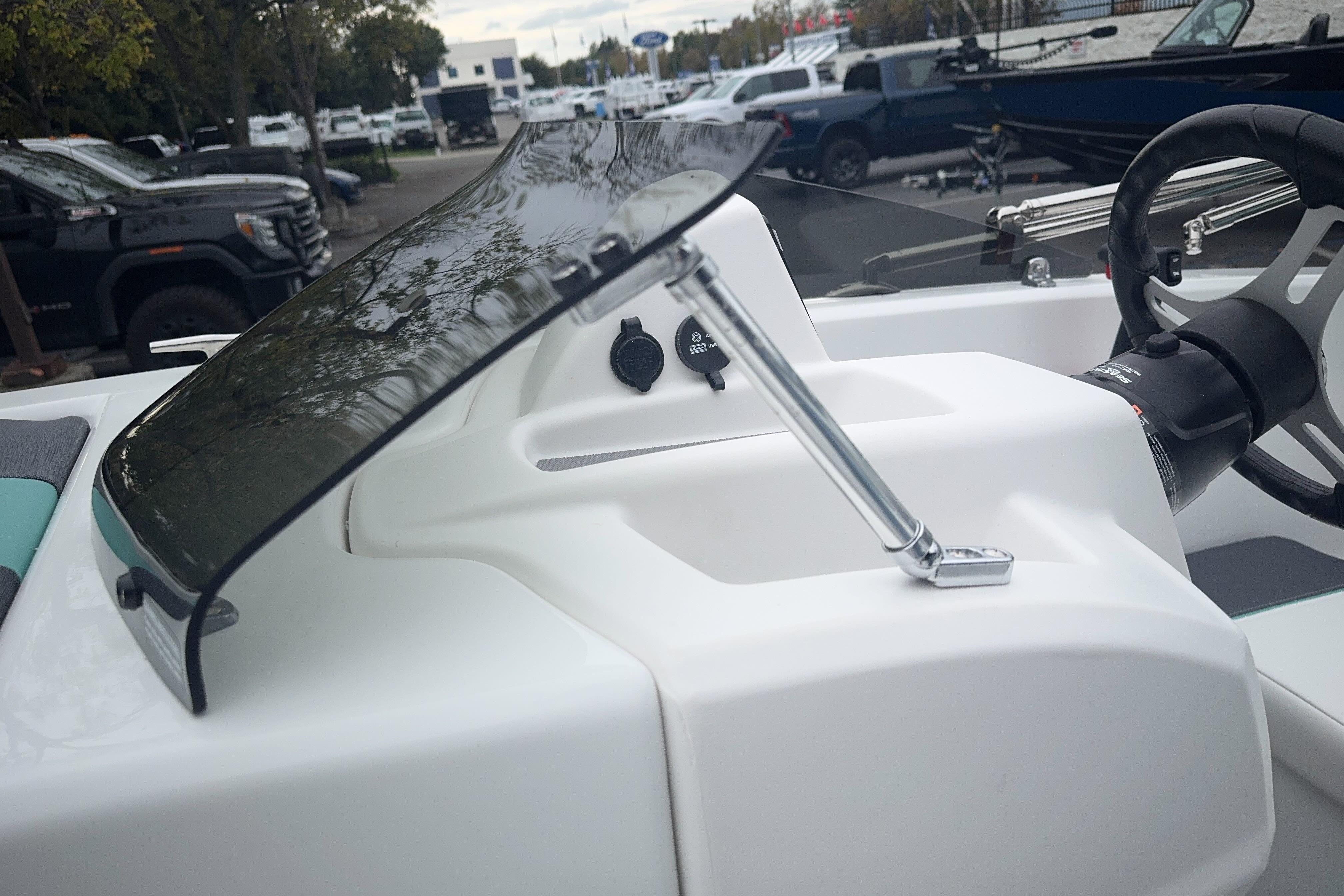2026 Tahoe T18 boat dashboard with steering wheel and windshield.