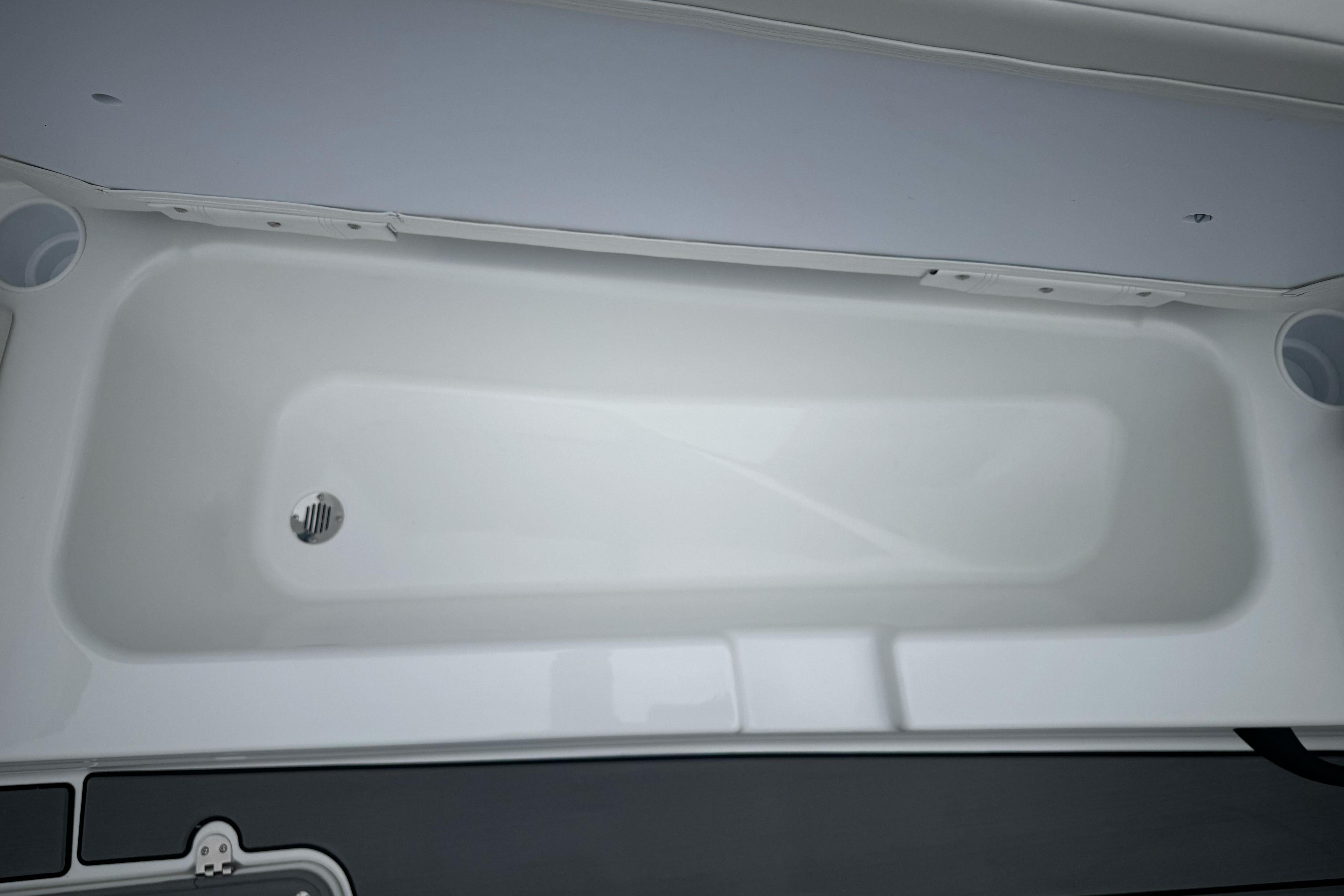 2026 Tahoe T18 boat interior, featuring a sleek white storage compartment.