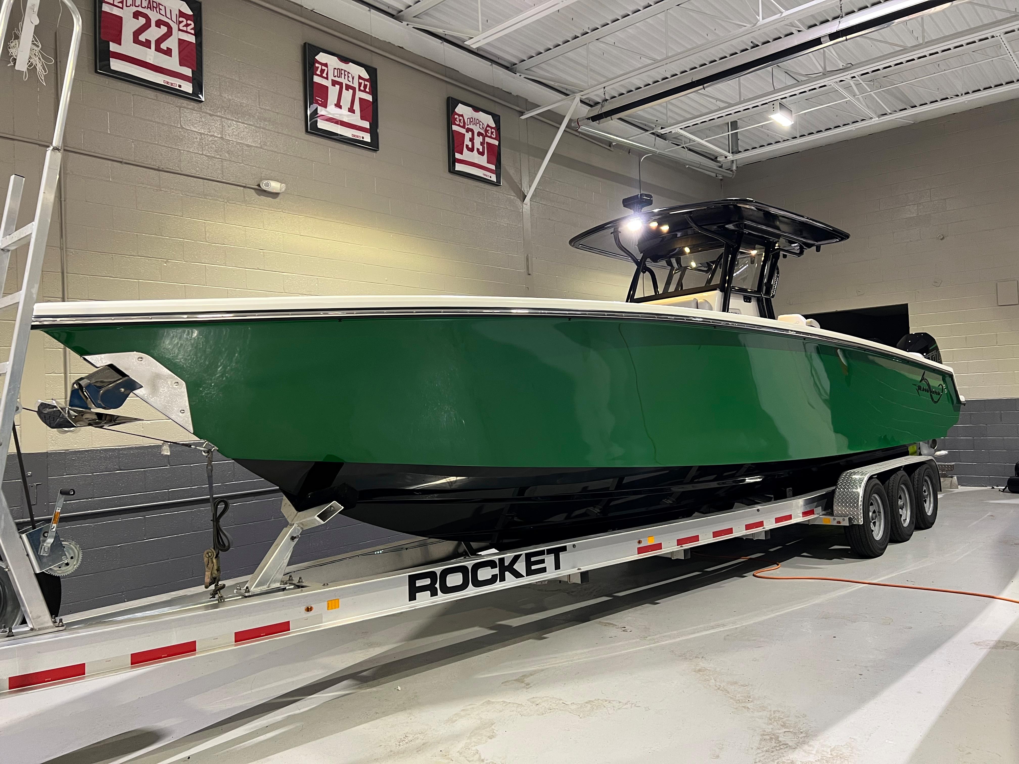Blackwater-36 Sport 2022 -MI-US-2022 Blackwater 36 Sport boat in green on a Rocket trailer indoors.-8355779 | Thumbnail