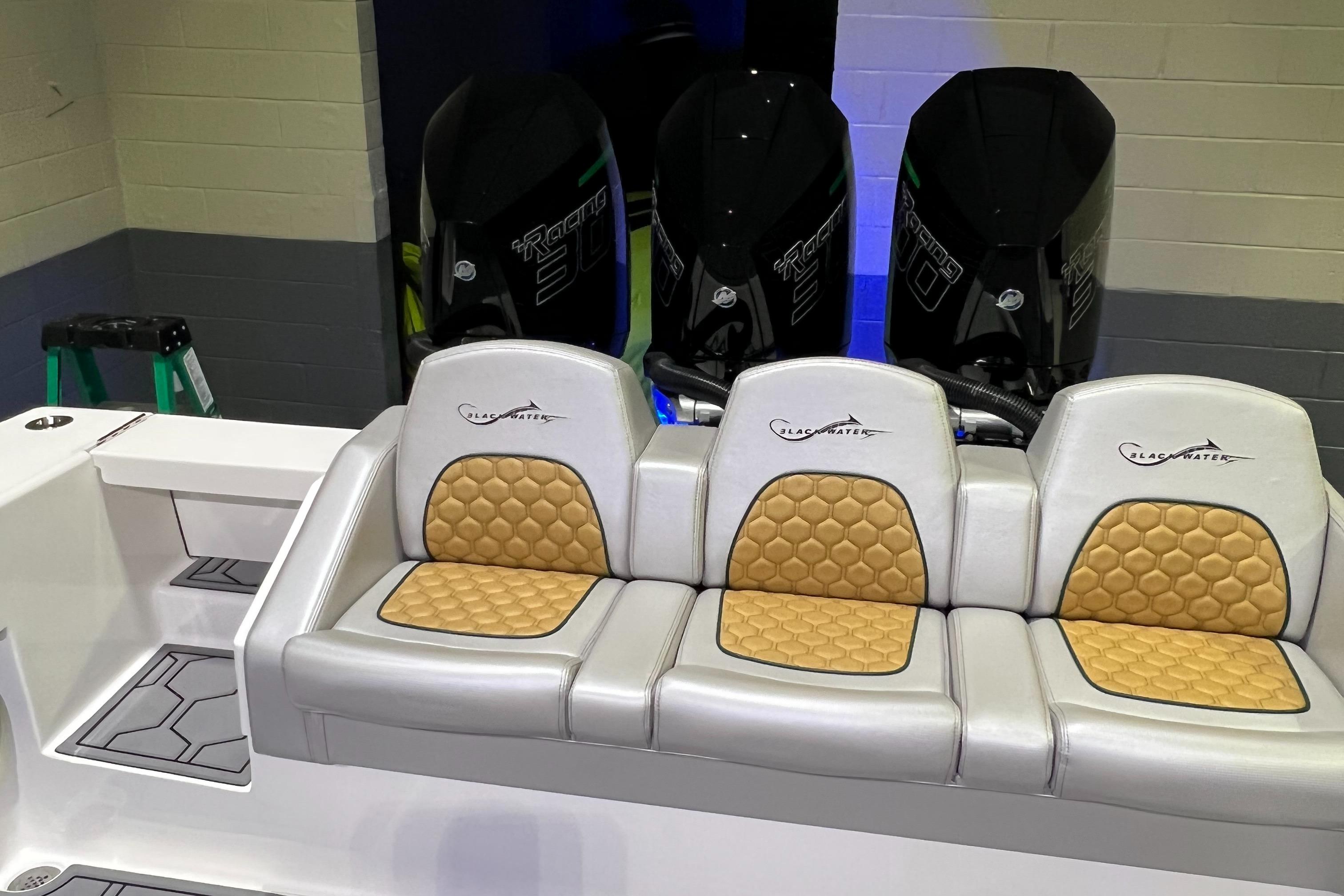 Blackwater-36 Sport 2022 -MI-US-2022 Blackwater 36 Sport boat seating with triple engines in a showroom.-8355779 | Thumbnail
