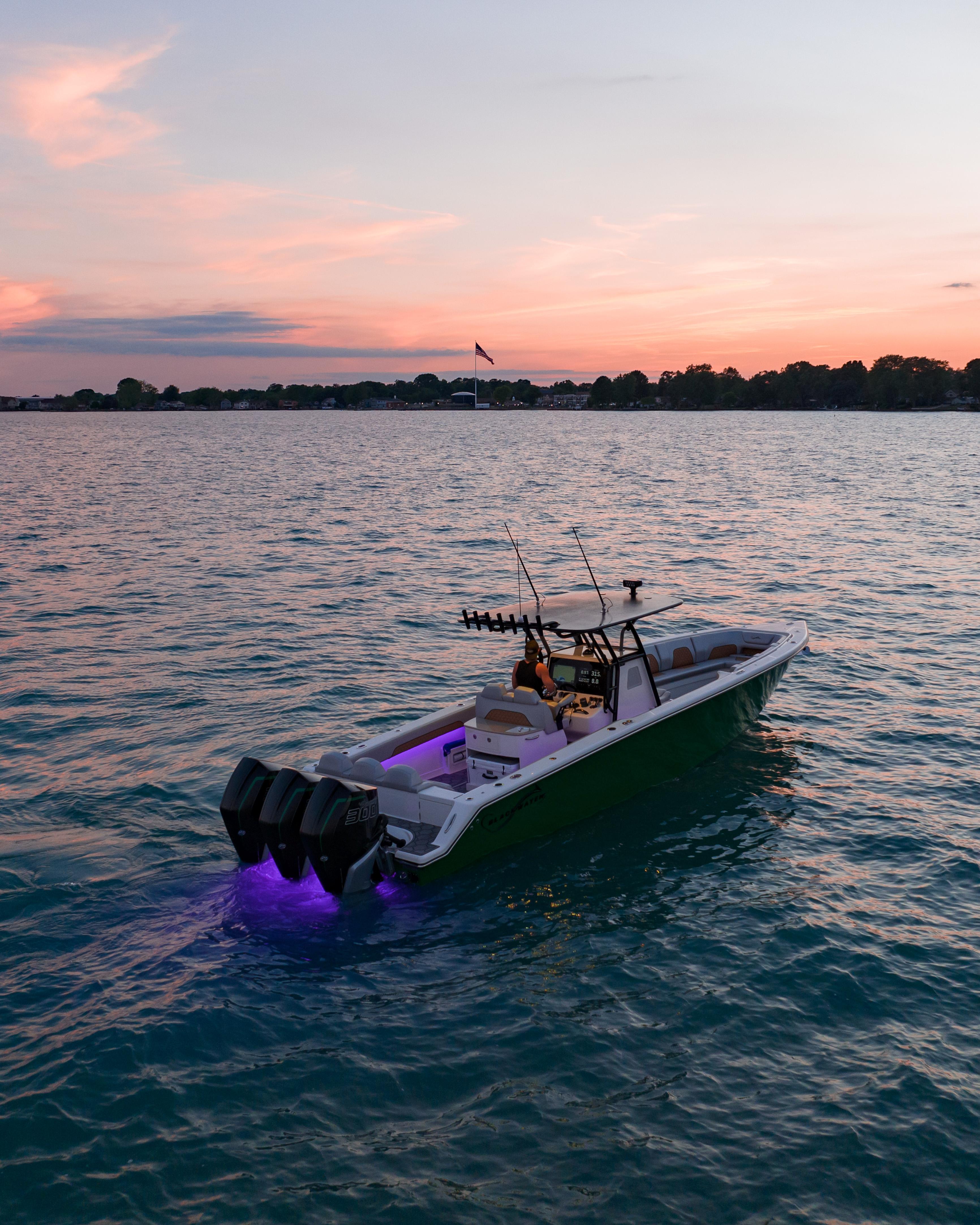 Blackwater-36 Sport 2022 -MI-US-2022 Blackwater 36 Sport boat on water at sunset with glowing lights.-8355779 | Thumbnail