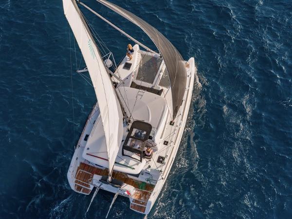 Aerial view of 2020 Lagoon 40 catamaran sailing on blue ocean waters.