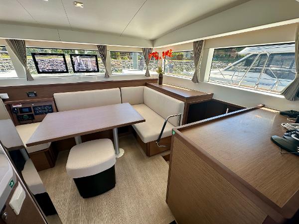 Modern interior of 2020 Lagoon 40 catamaran with spacious seating and large windows.
