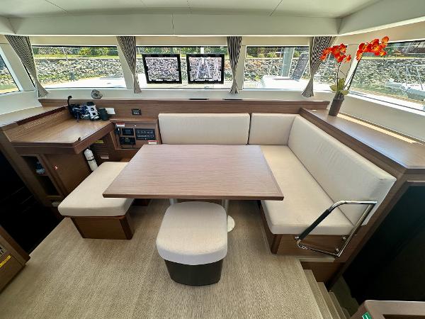 Interior of 2020 Lagoon 40 catamaran with modern seating and table arrangement.