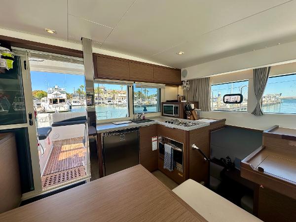 Interior of 2020 Lagoon 40 catamaran with modern kitchen and marina view.
