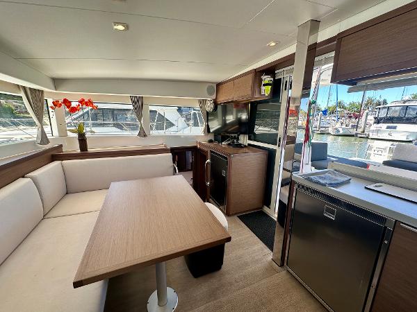 Modern interior of 2020 Lagoon 40 catamaran with dining area and marina view.