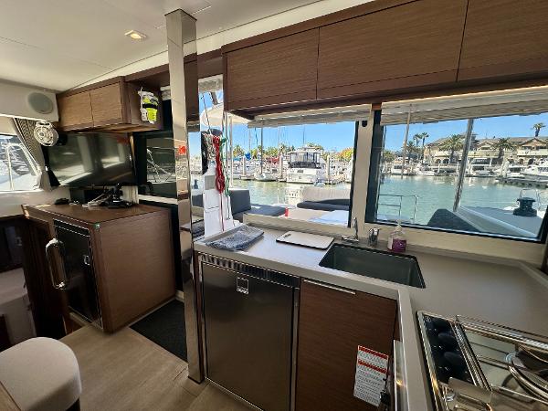 Interior of 2020 Lagoon 40 catamaran with modern kitchen and marina view.